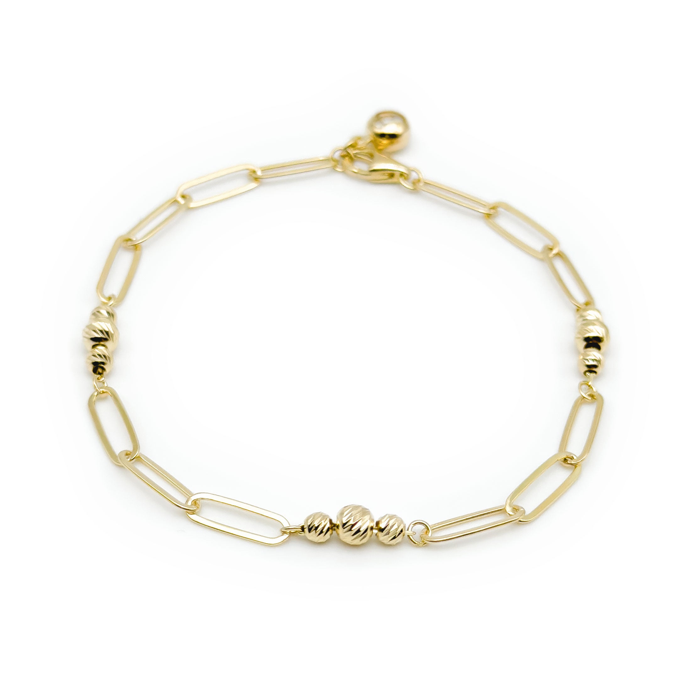 A gold paperclip chain bracelet with small textured bead accents, displayed on a clean white background.