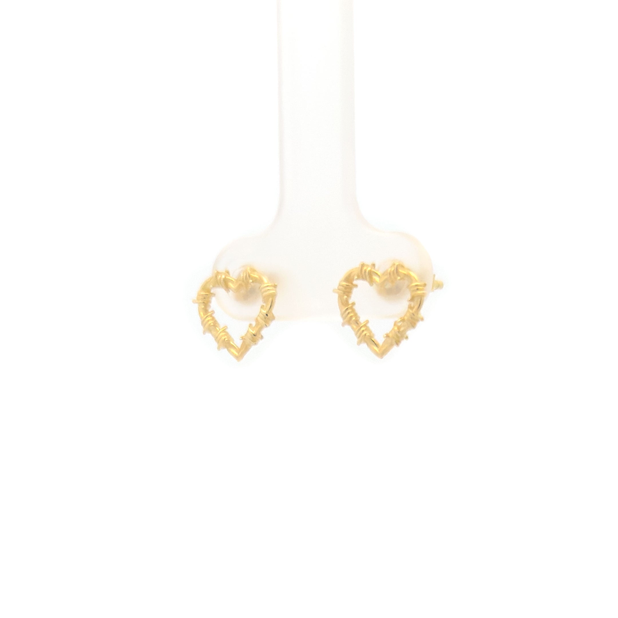 Gold heart-shaped earrings on a white background side