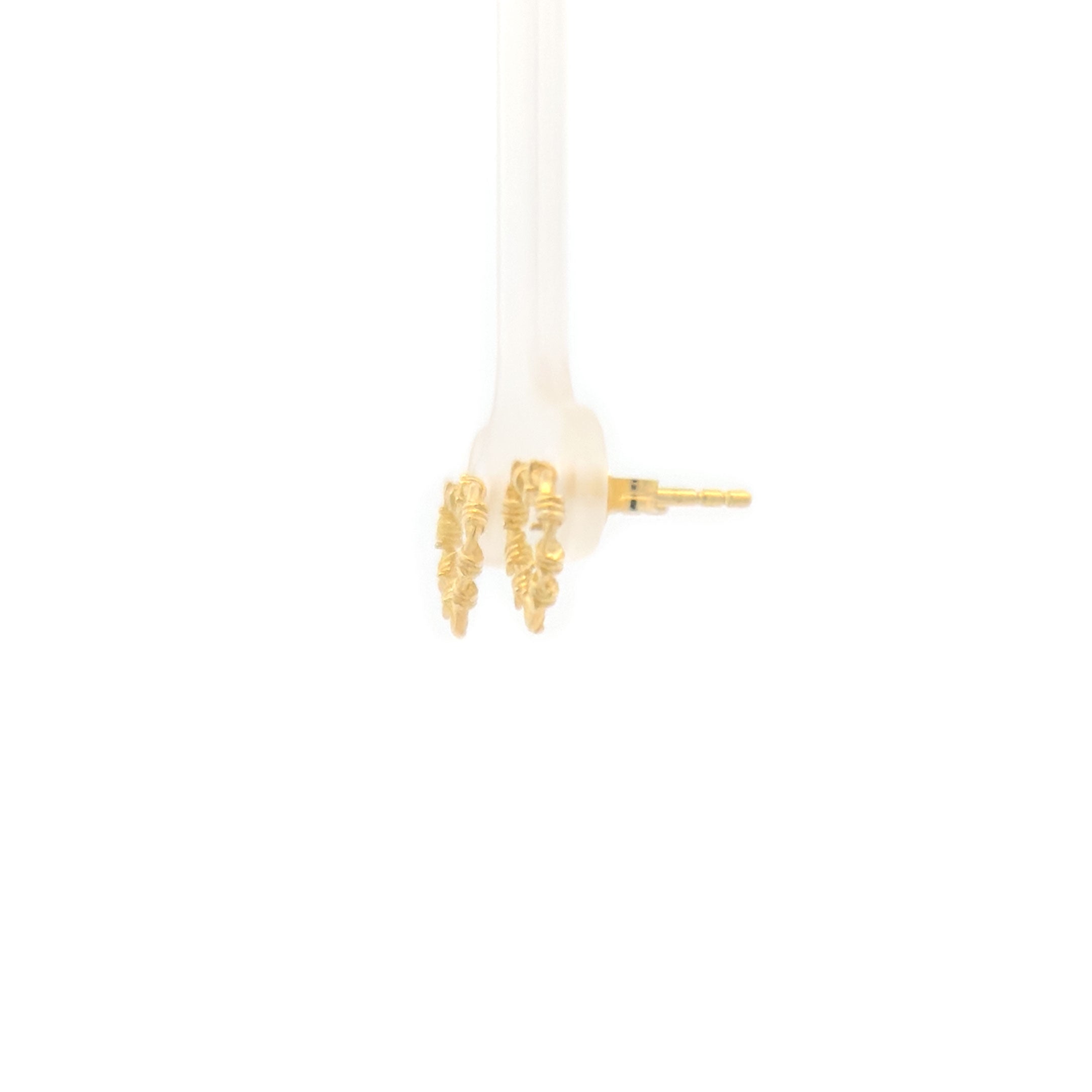Gold heart-shaped earrings on a white background back