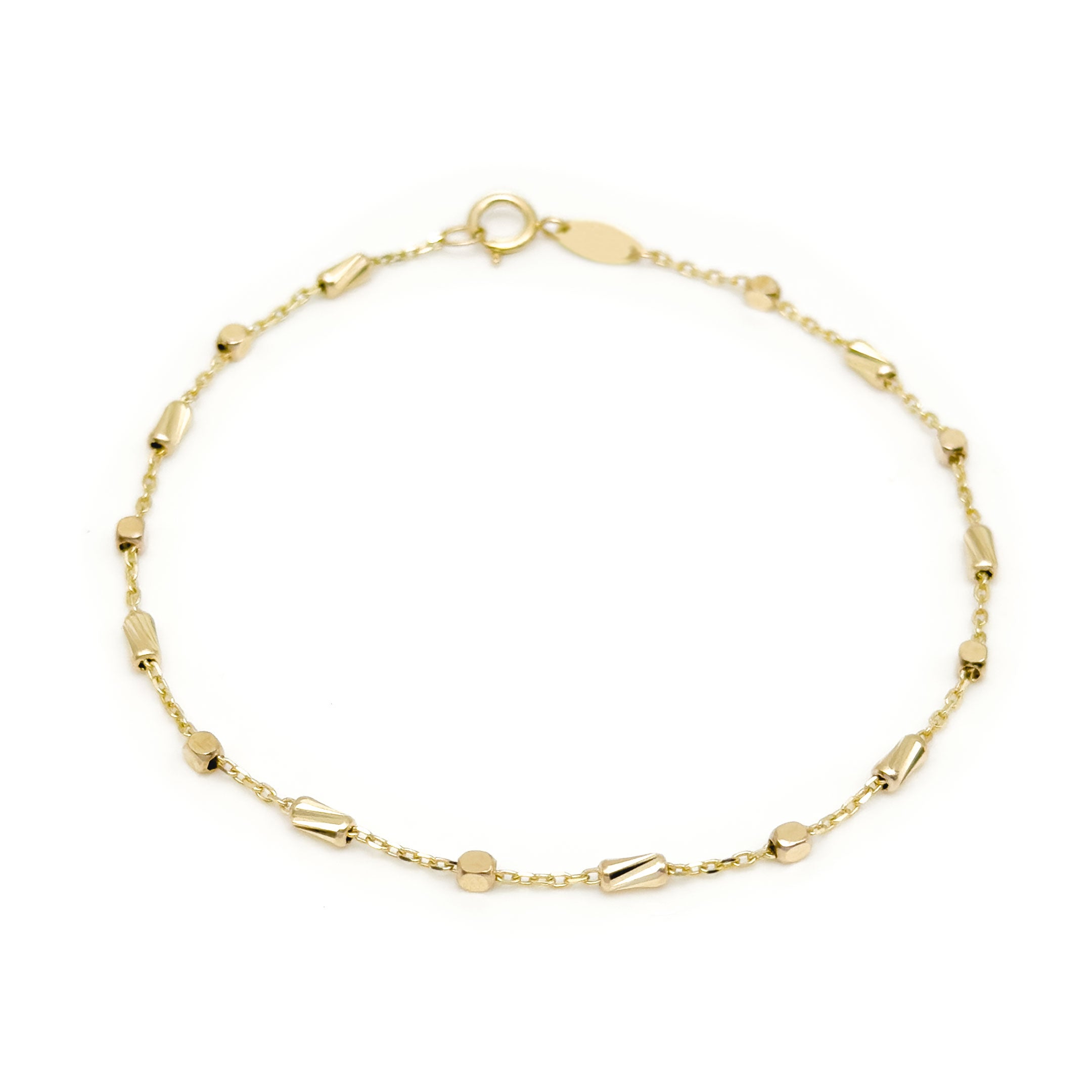 A delicate yellow gold bracelet with small polished bead-like links and elongated cylinder accents, displayed on a clean white background.