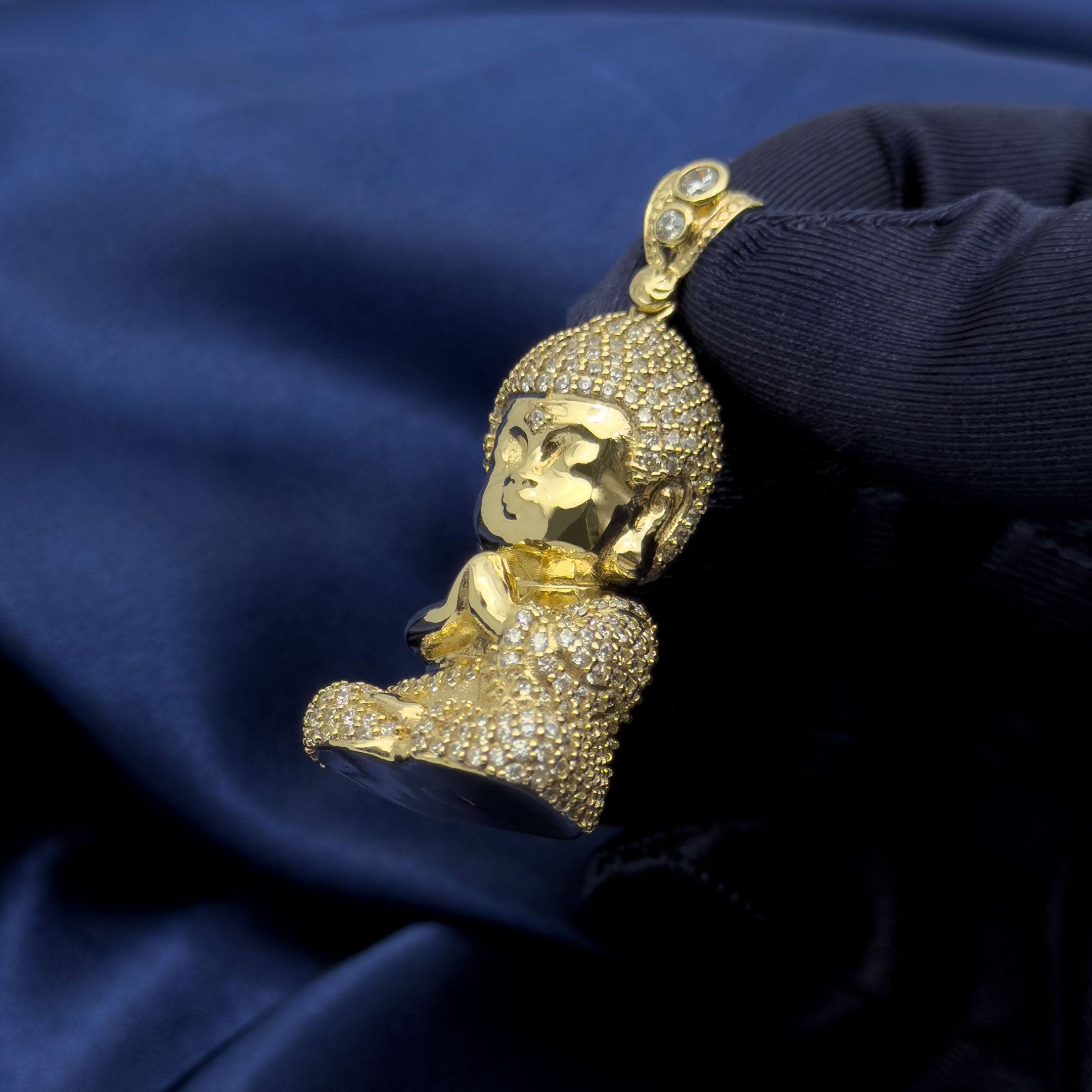 10k Yellow Gold Baby Buddha Full Body Pendant with CZ Stones on blue background