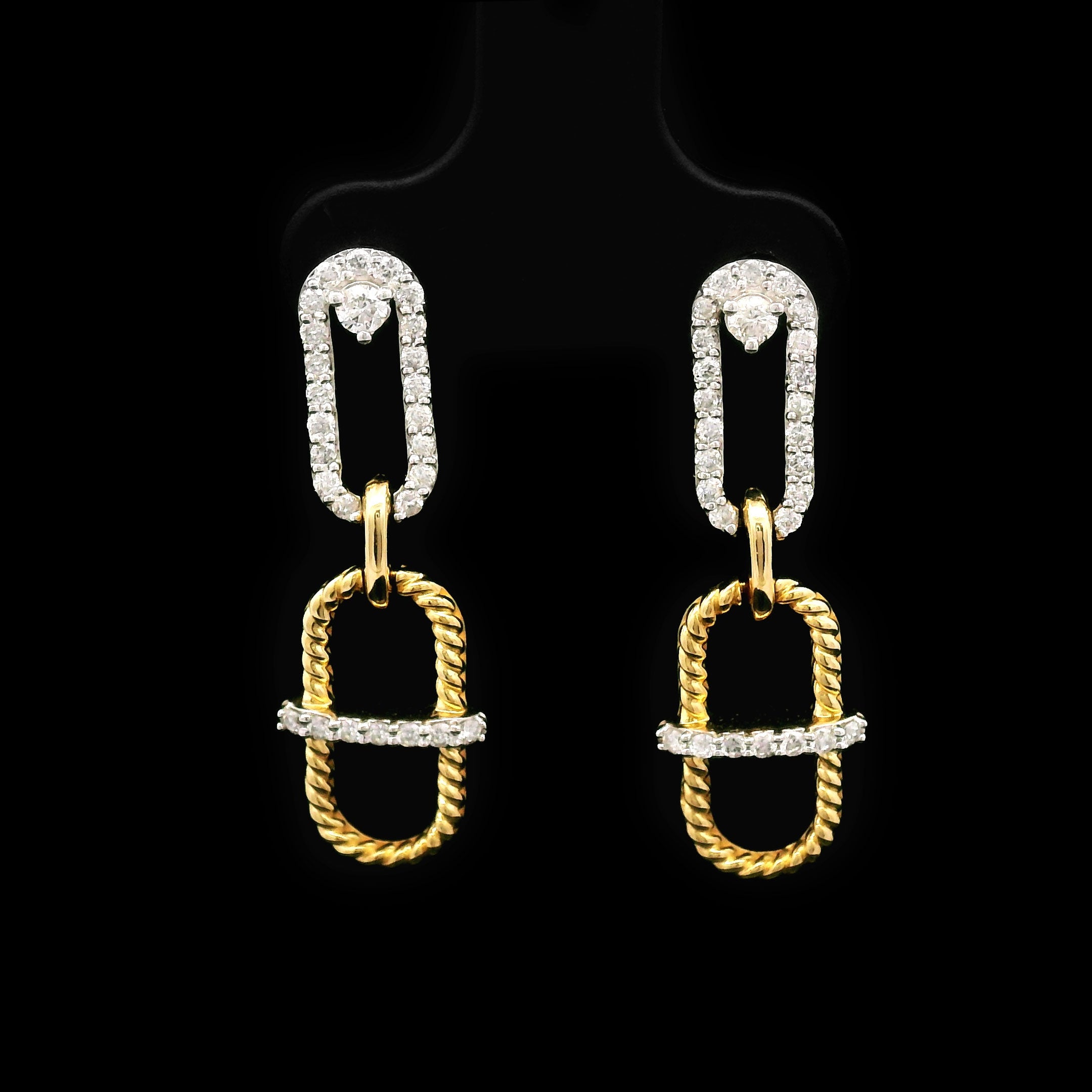 Pair of 14k gold earrings on a black background