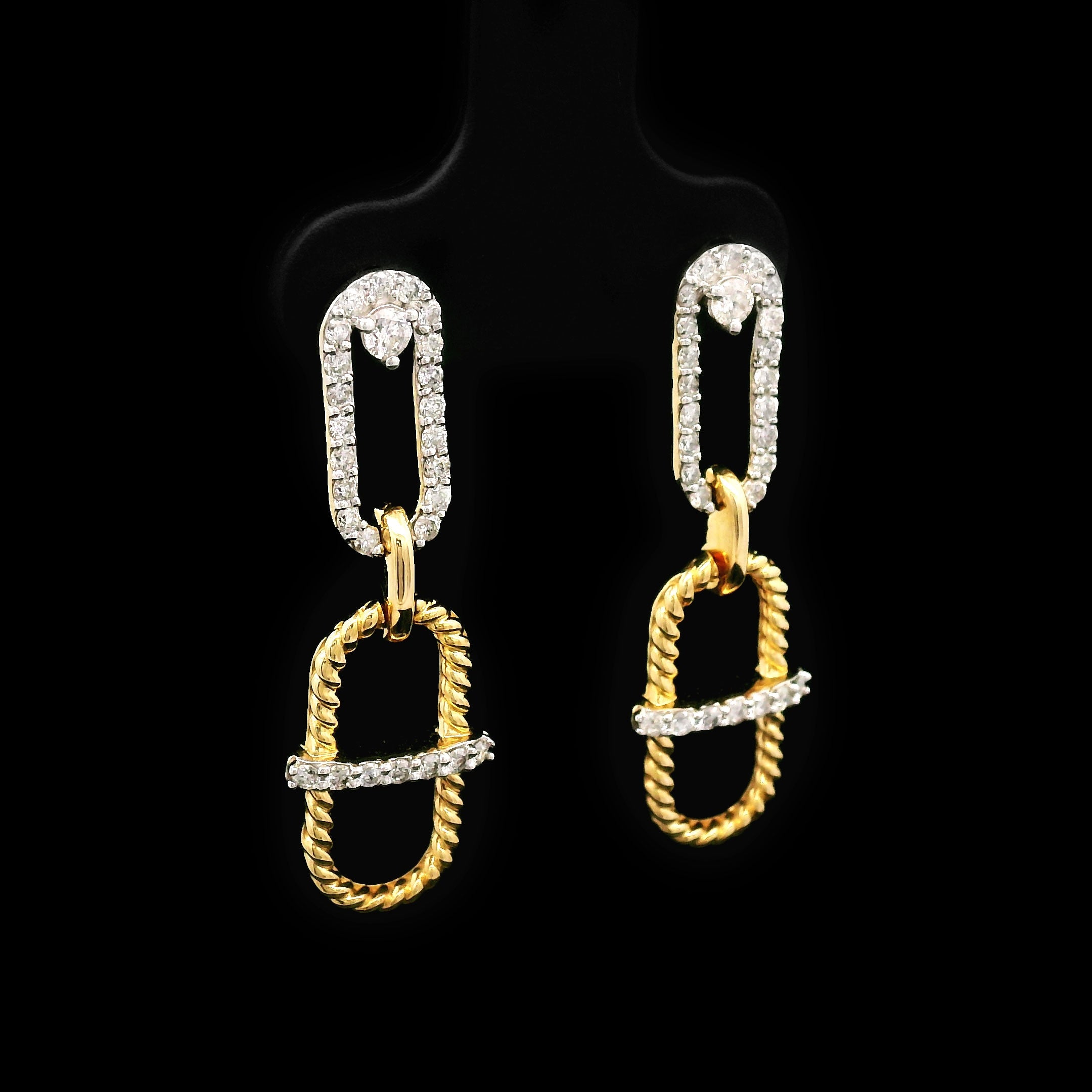 Pair of 14k gold earrings on a black background left