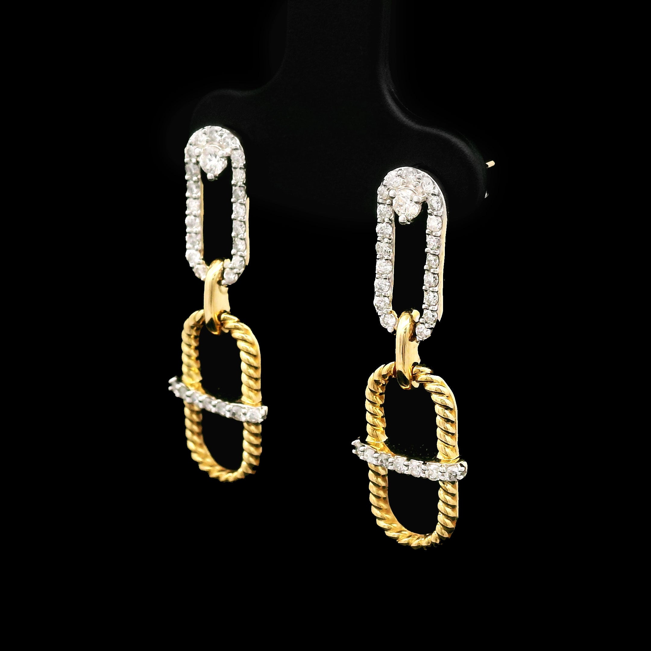 Pair of 14k gold earrings on a black background right