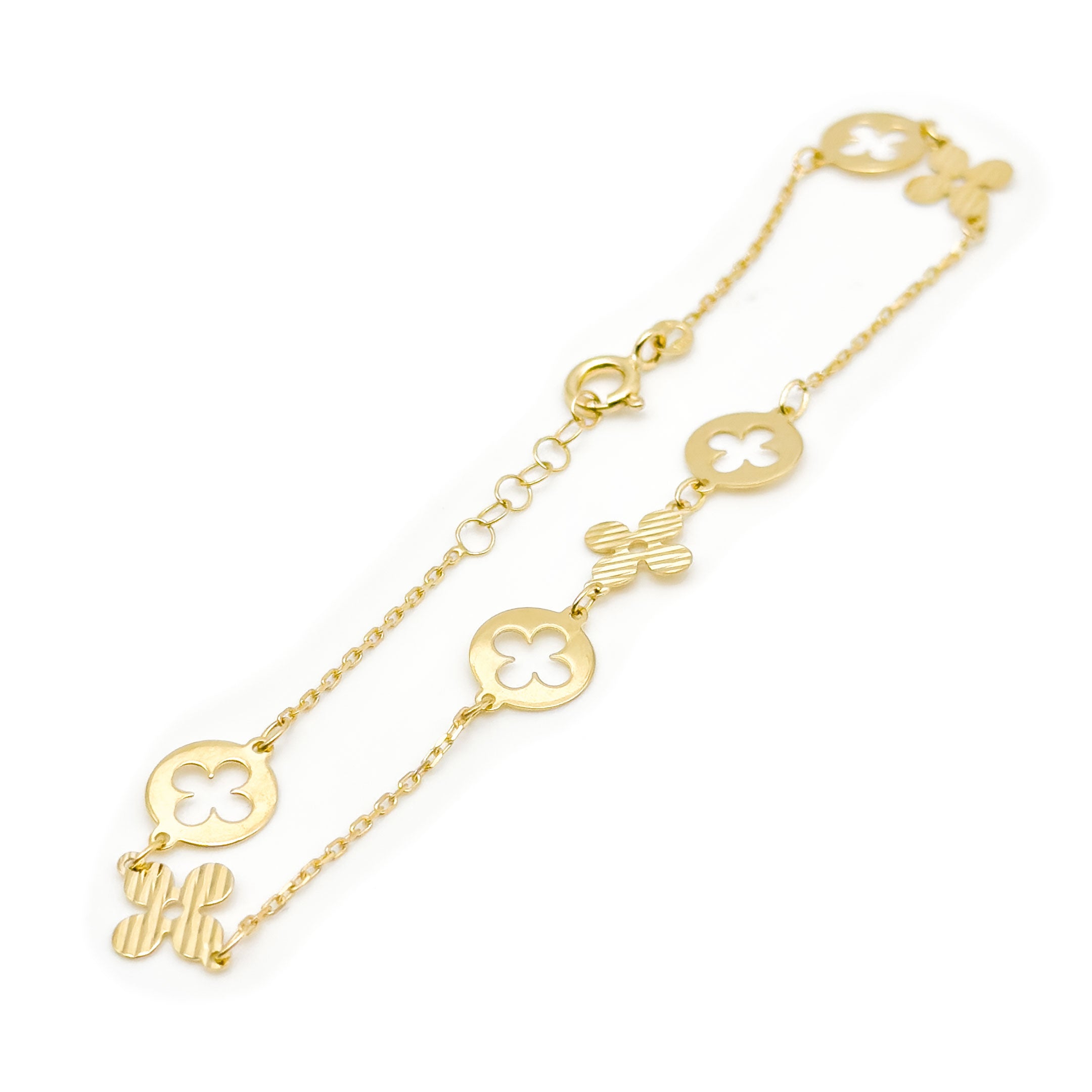 A delicate gold chain bracelet featuring four leaf clover charms with round cutout clover motifs, displayed on a clean white background. close