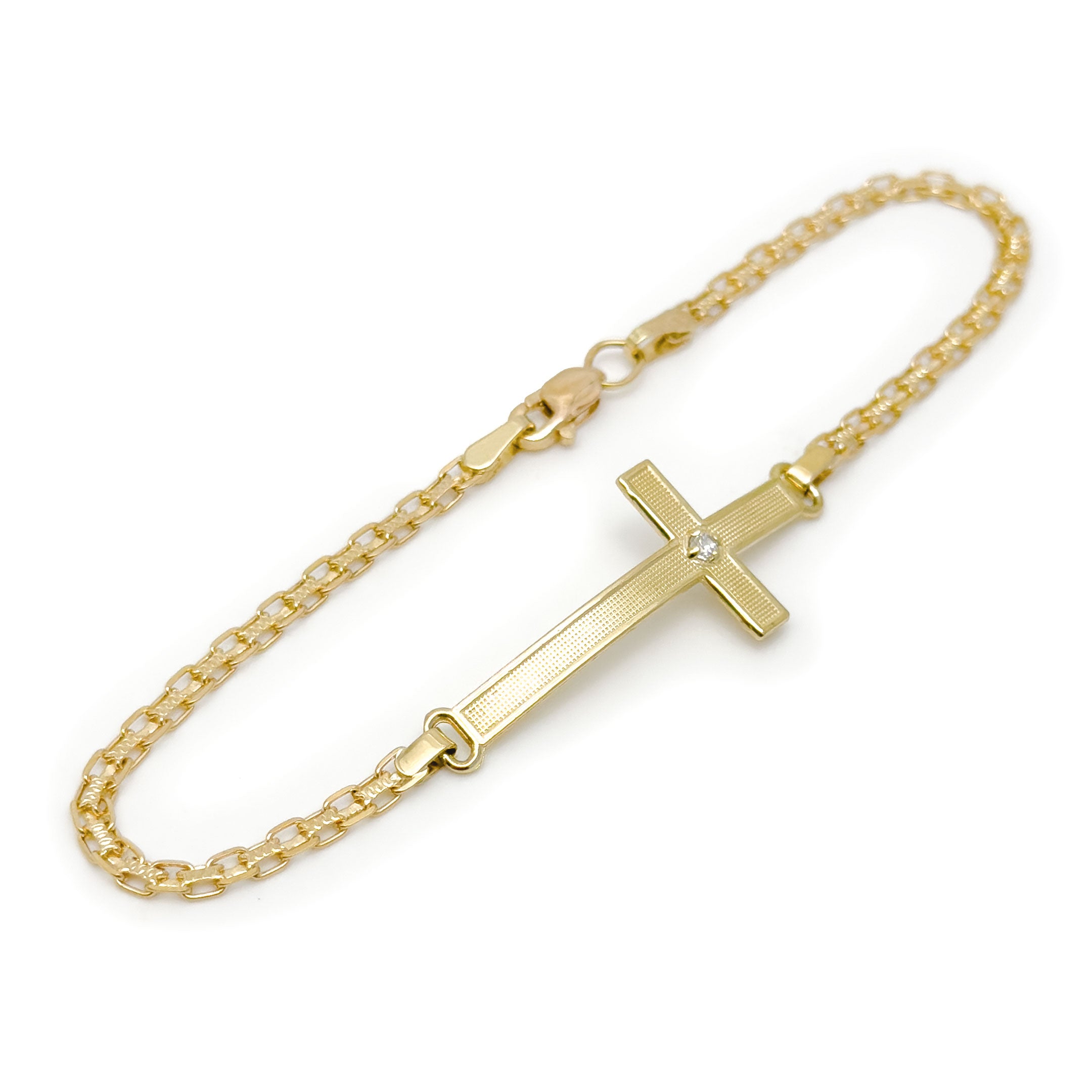 A gold chain bracelet with a horizontal cross pendant featuring a small cz stone at the center, photographed on a plain white background. close