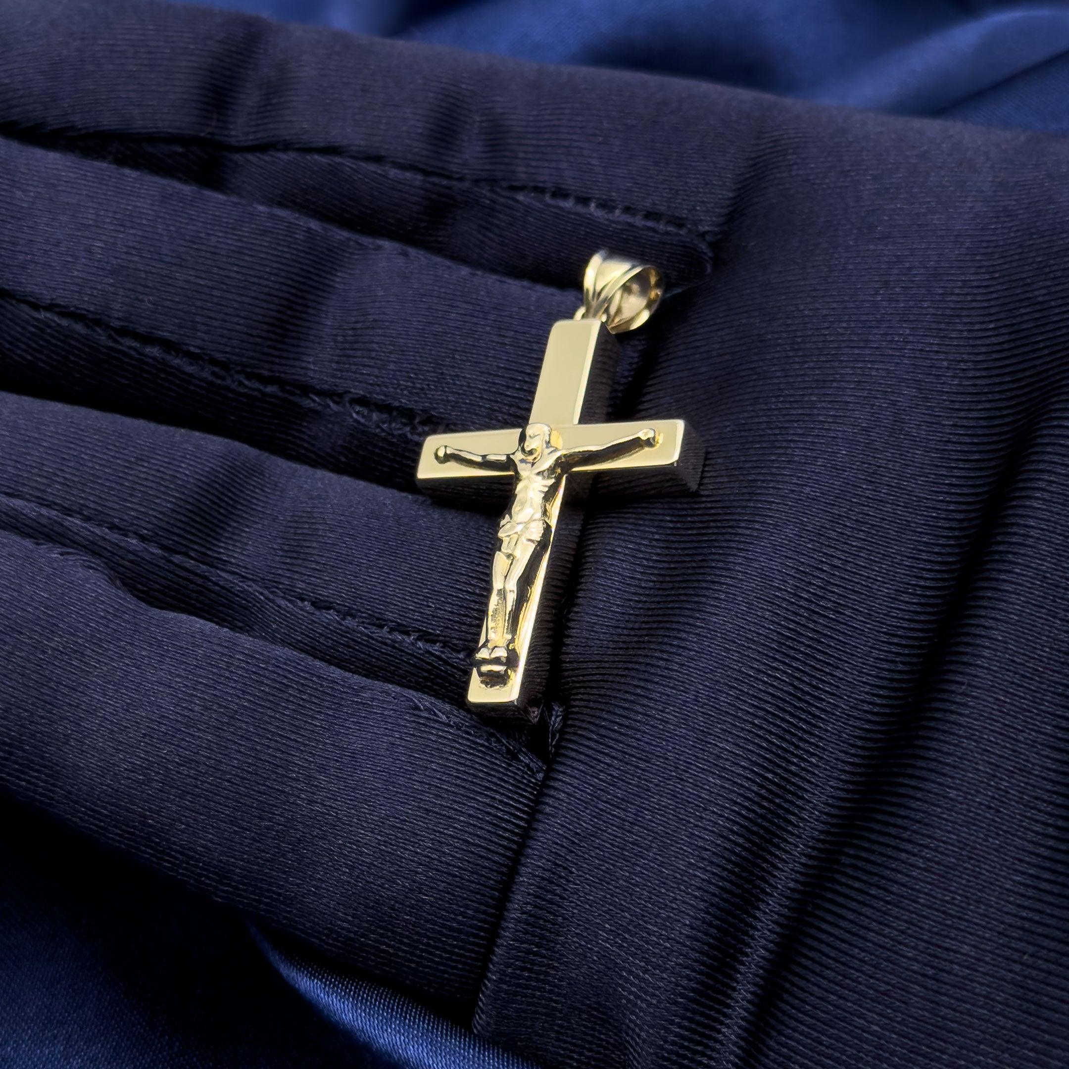 10k yellow gold Hollow Square-cut Crucifix Cross Pendant in hand with blue glove