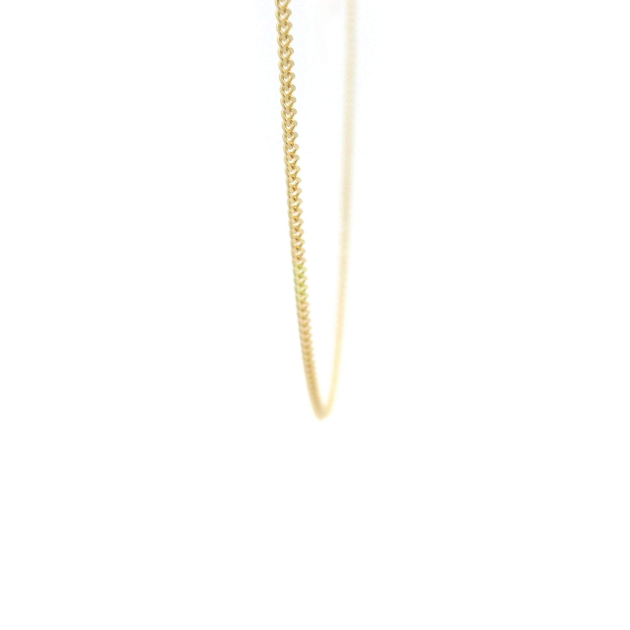 10k gold thin Cuban Chain on white background close up