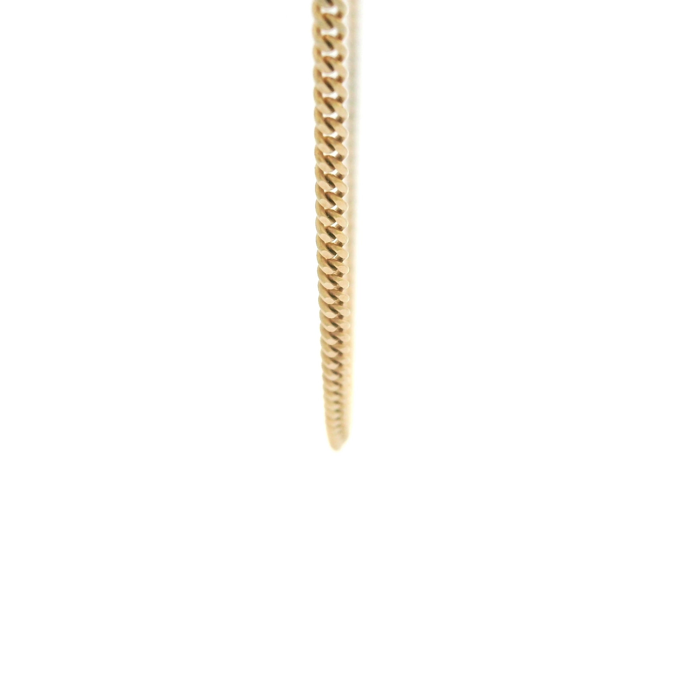 10k solid gold cuban link chain 1.5mm on a white background close up