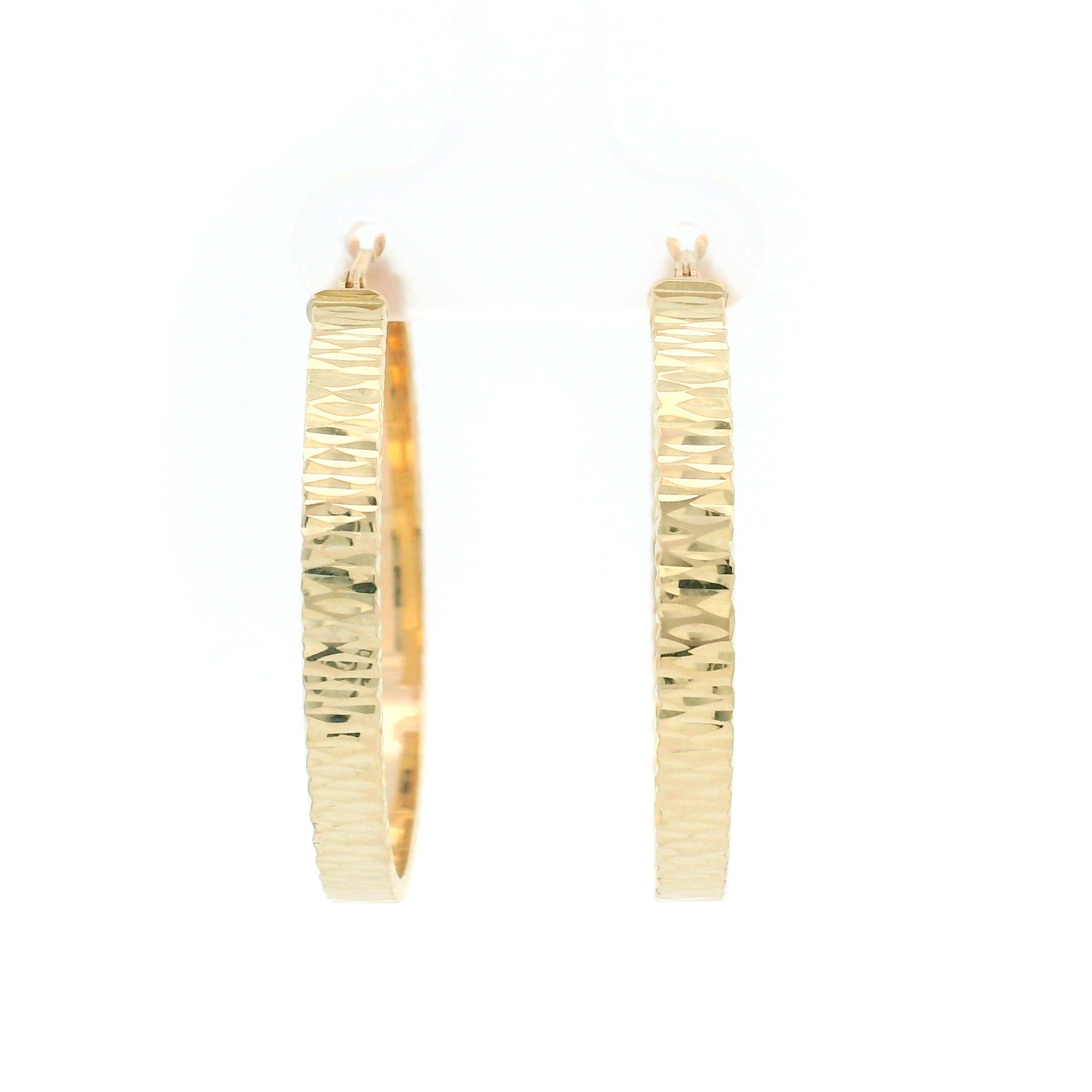 Gold diamond cut hoop earrings on a white background front view