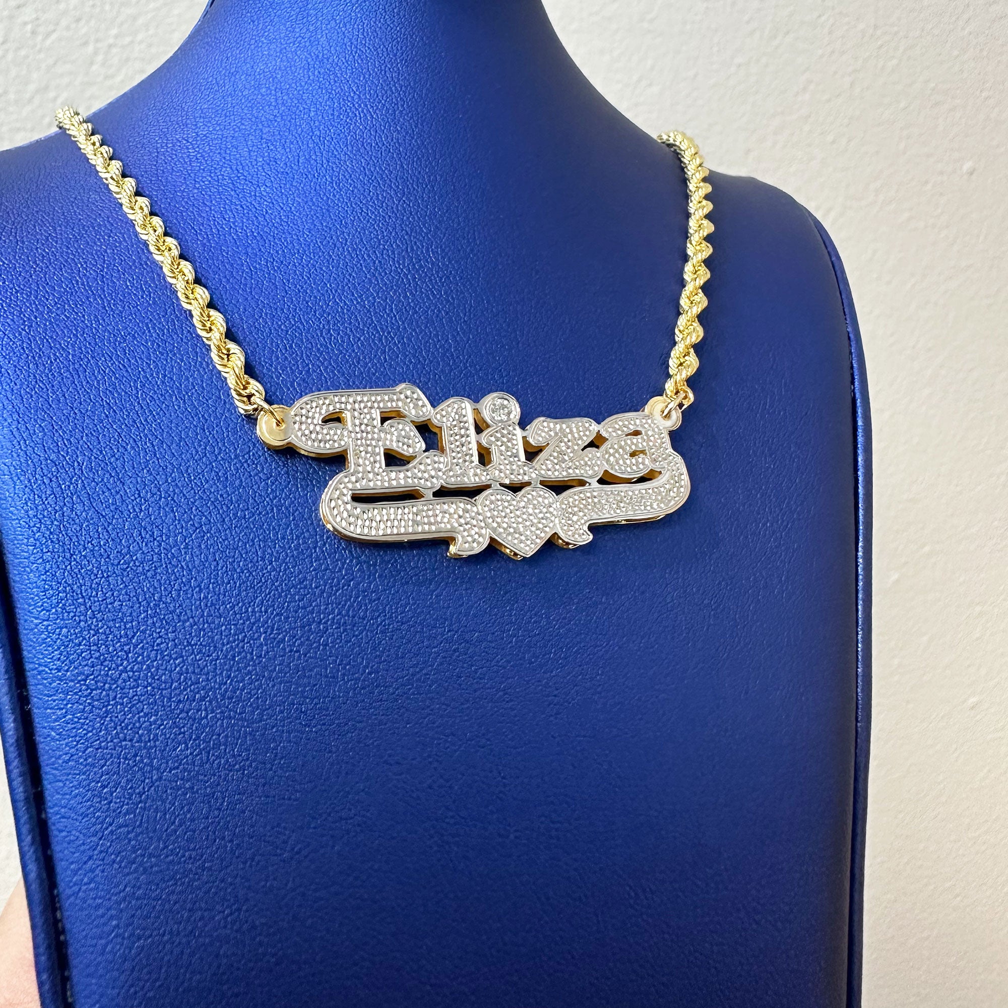 Custom Eliza name pendant with diamond cut and diamond in the "i" displayed on a rope chain