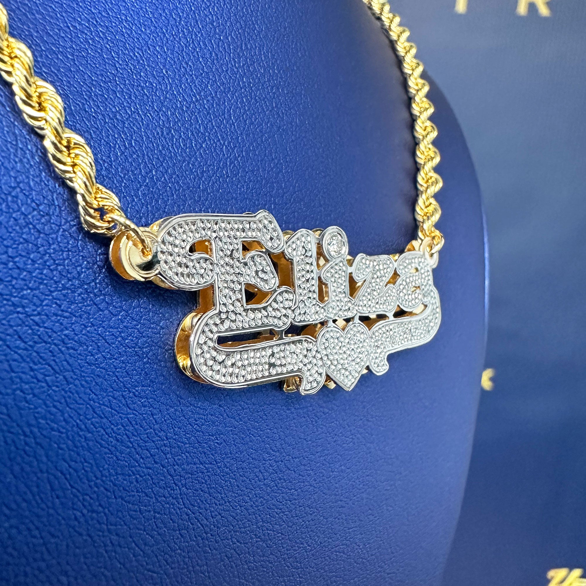 Custom Eliza name pendant with diamond cut and diamond in the "i" displayed on a rope chain side