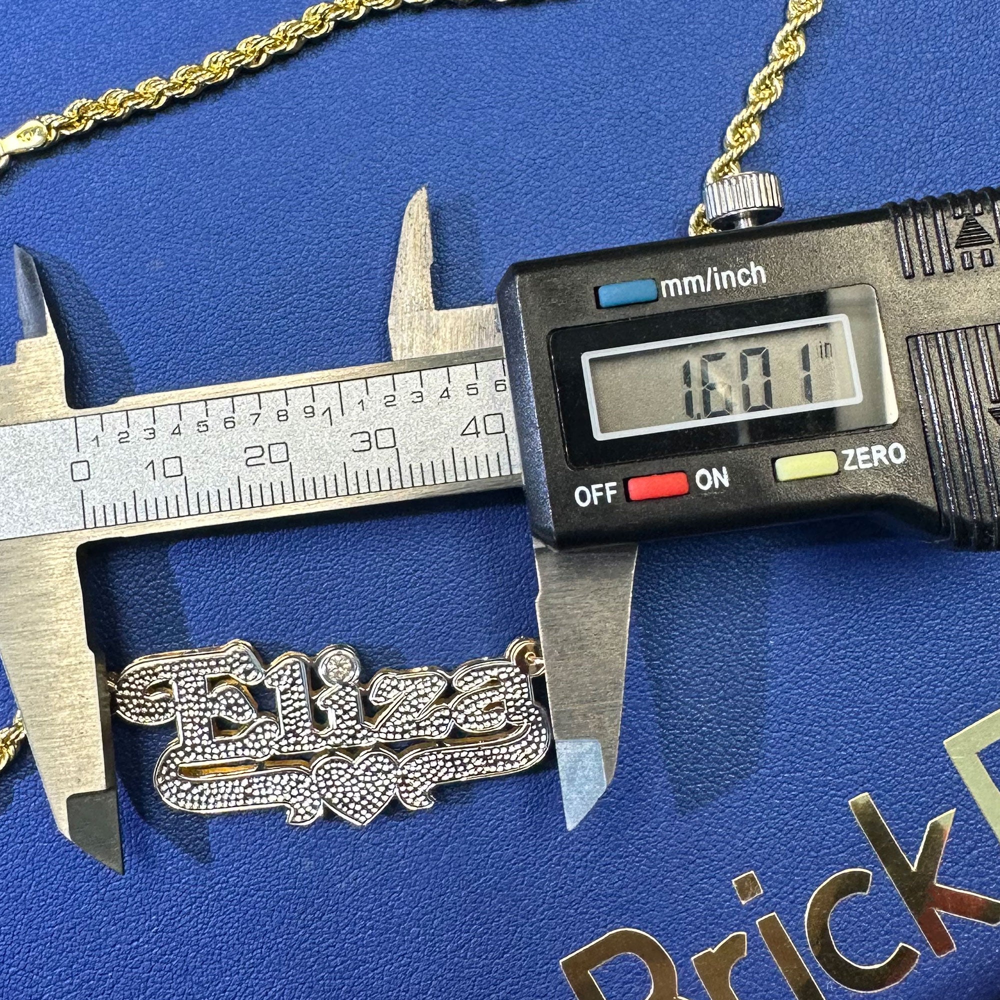 Custom Eliza name pendant with diamond cut and diamond in the "i" displayed on a rope chain length measurement