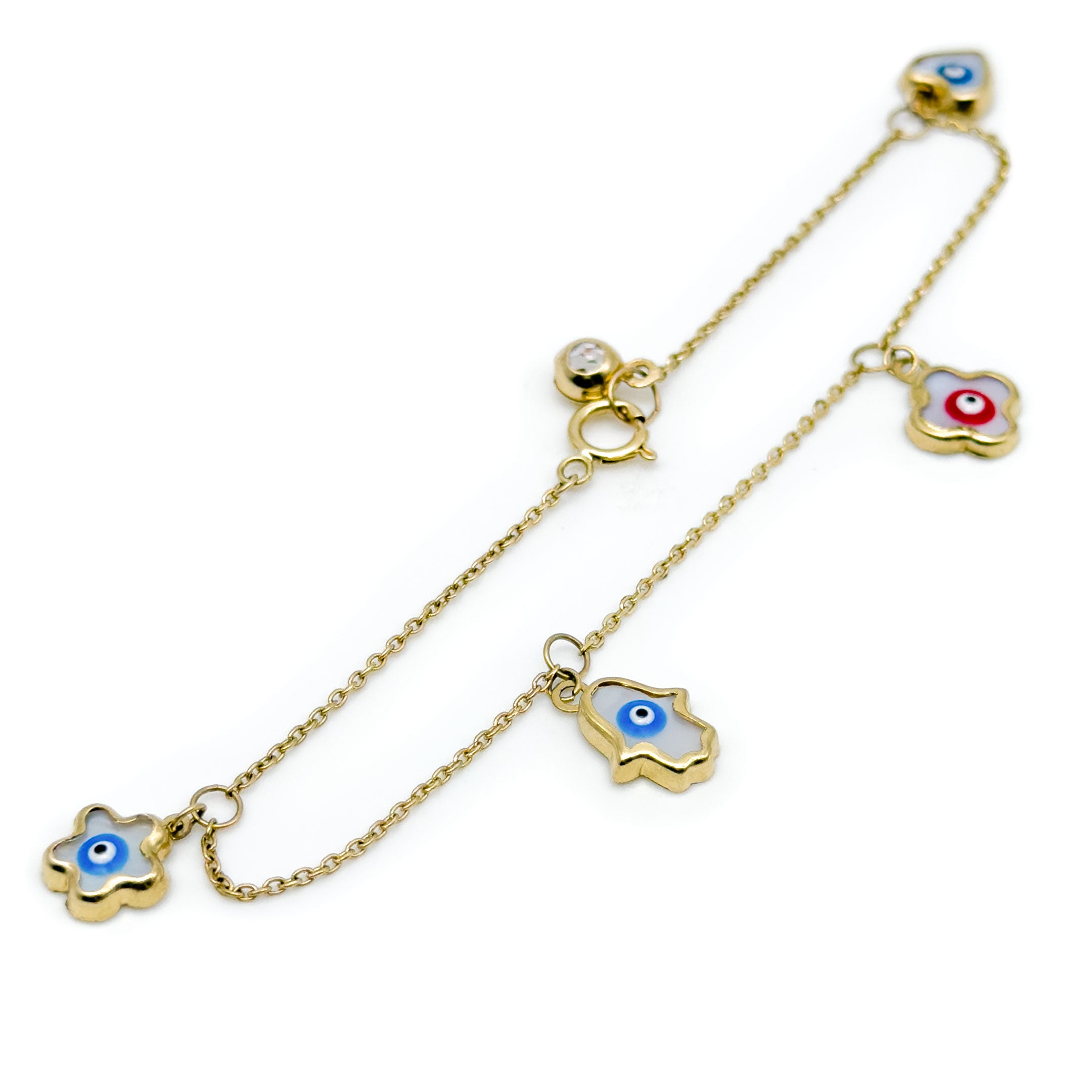 A gold charm bracelet featuring four evil eye charms in different shapes, displayed on a clean white background. close