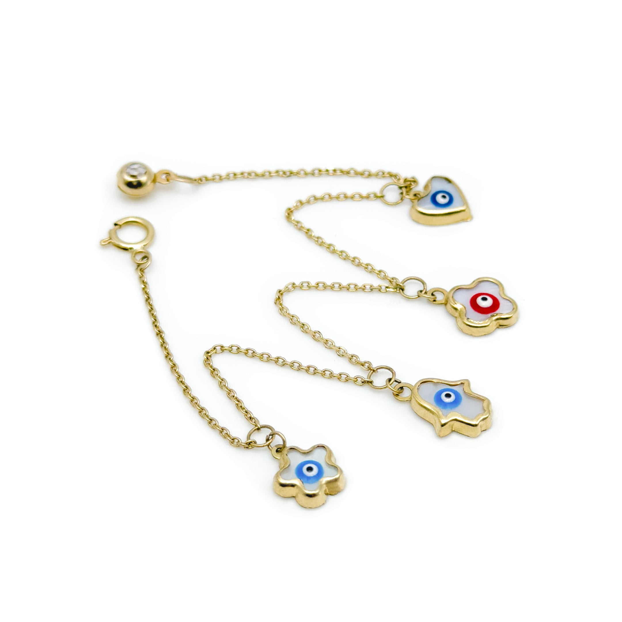 A gold charm bracelet featuring four evil eye charms in different shapes, displayed on a clean white background. close up of charms