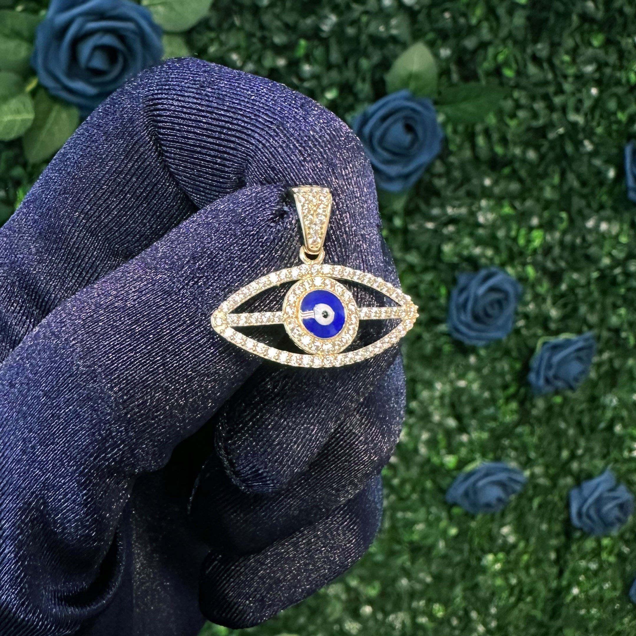 14k Blue Enamel Evil Eye Pendant in hand
