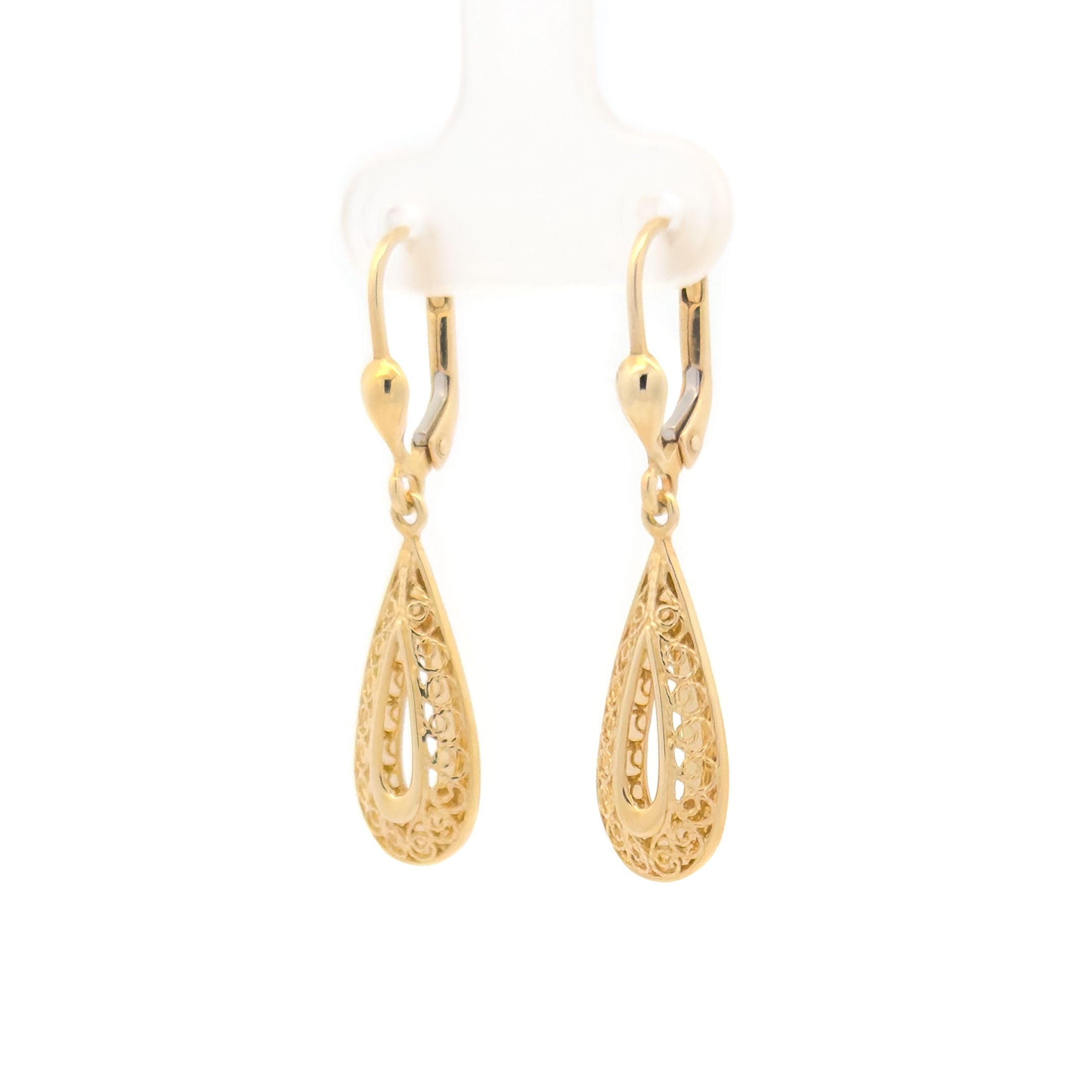 Gold teardrop hanging earrings on a white background side