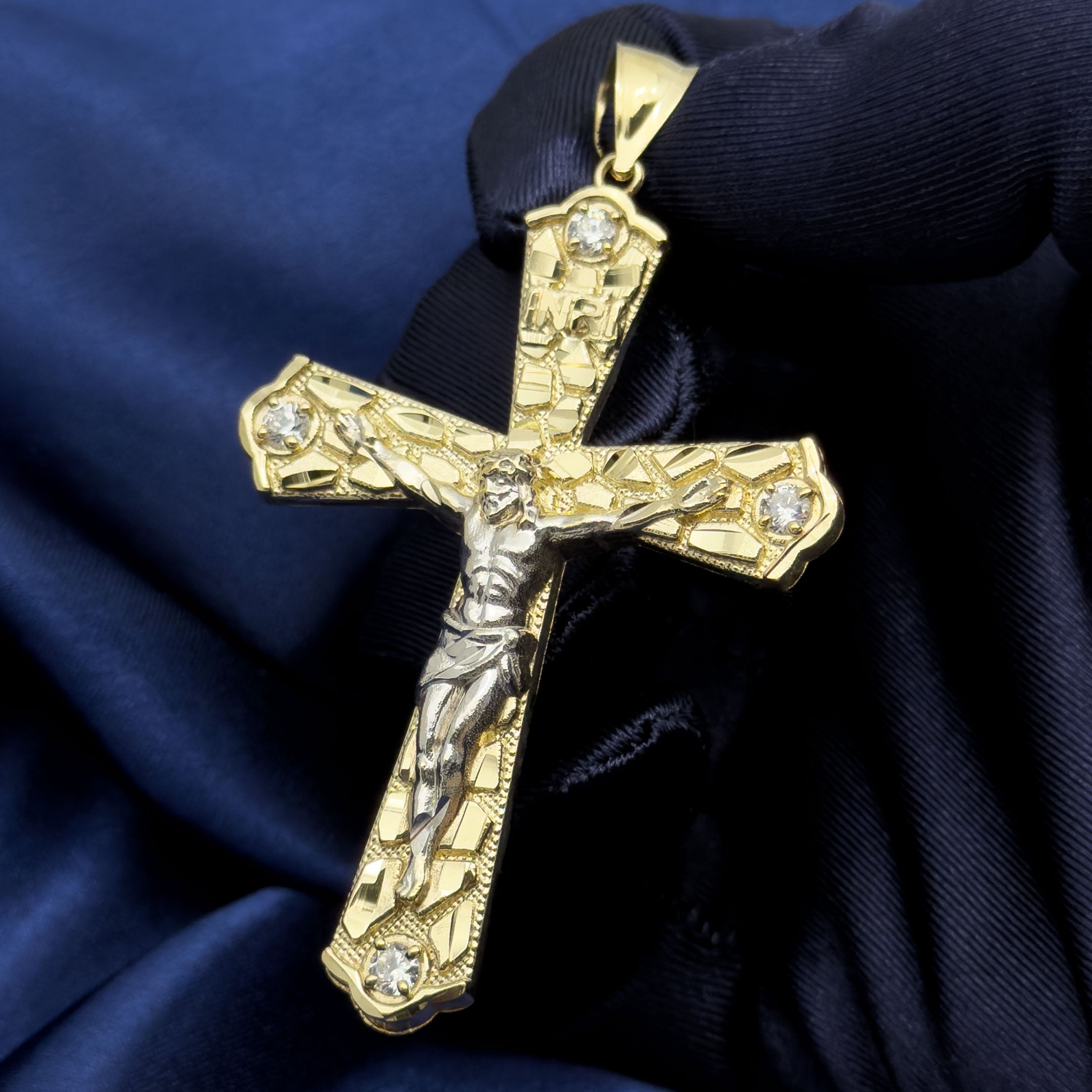 10k Yellow Gold Nugget Crucifix Flare Cross Pendant with blue background