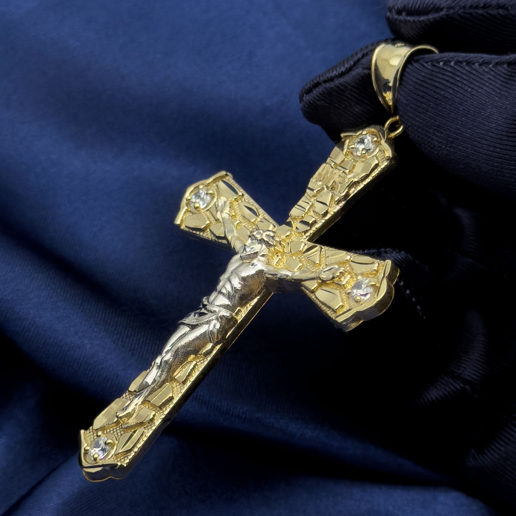 10k Yellow Gold Nugget Crucifix Flare Cross Pendant with blue background side view