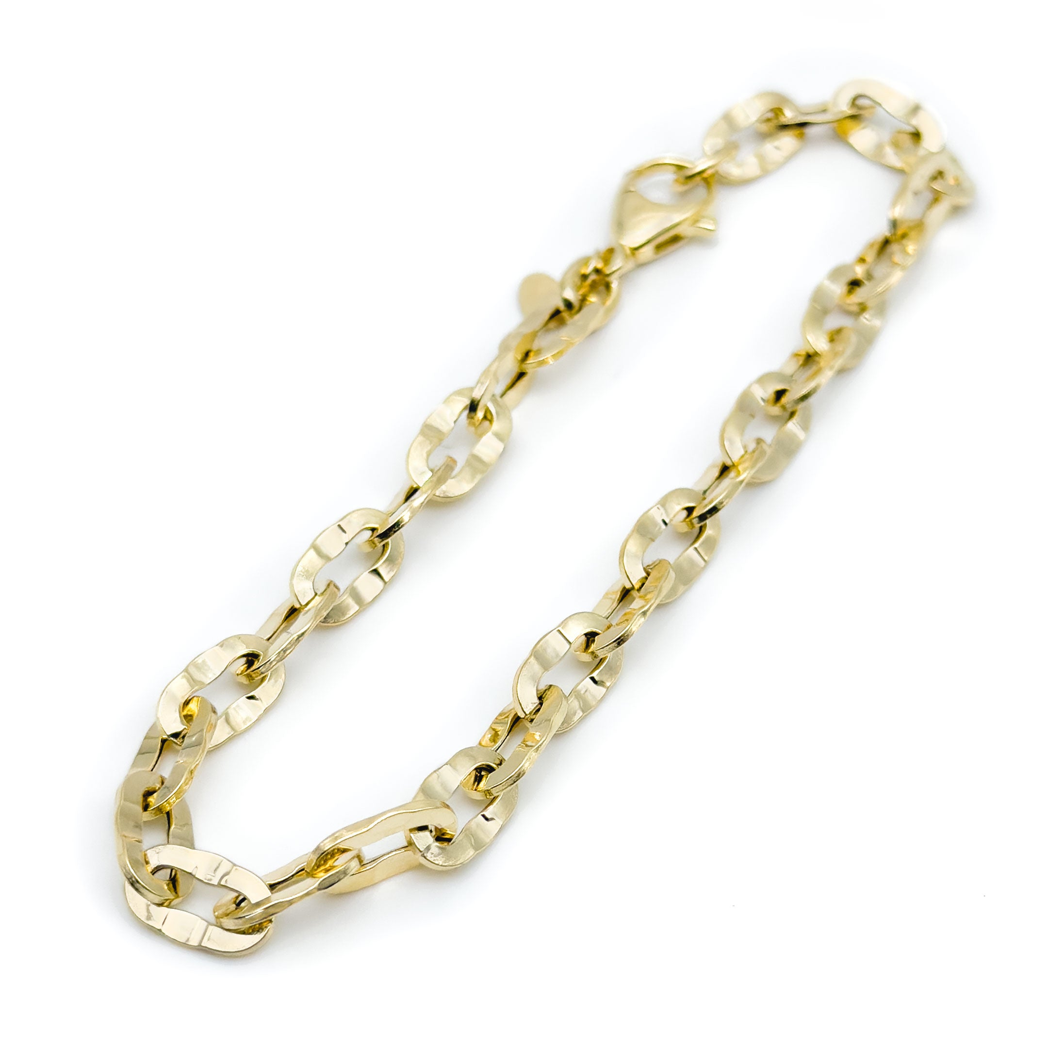 10k yellow gold cable link bracelet with hammered finish on a white background close up