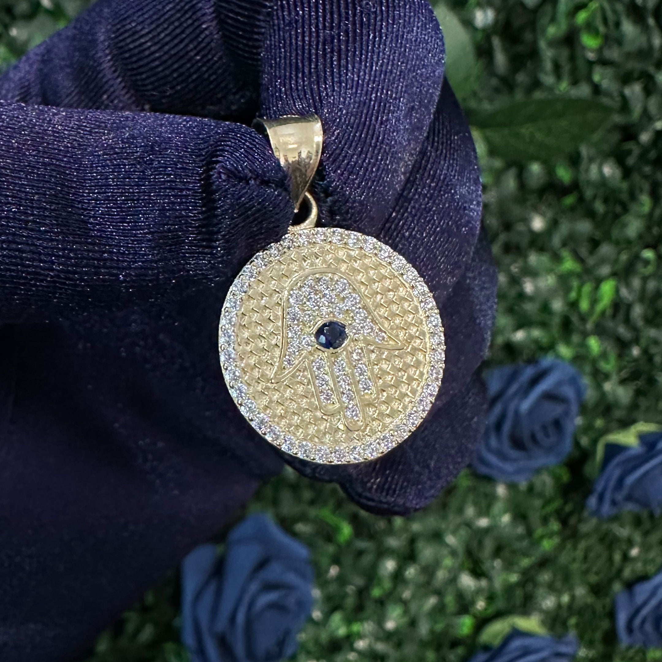 14k CZ Hamsa Hand Round Pendant in hand