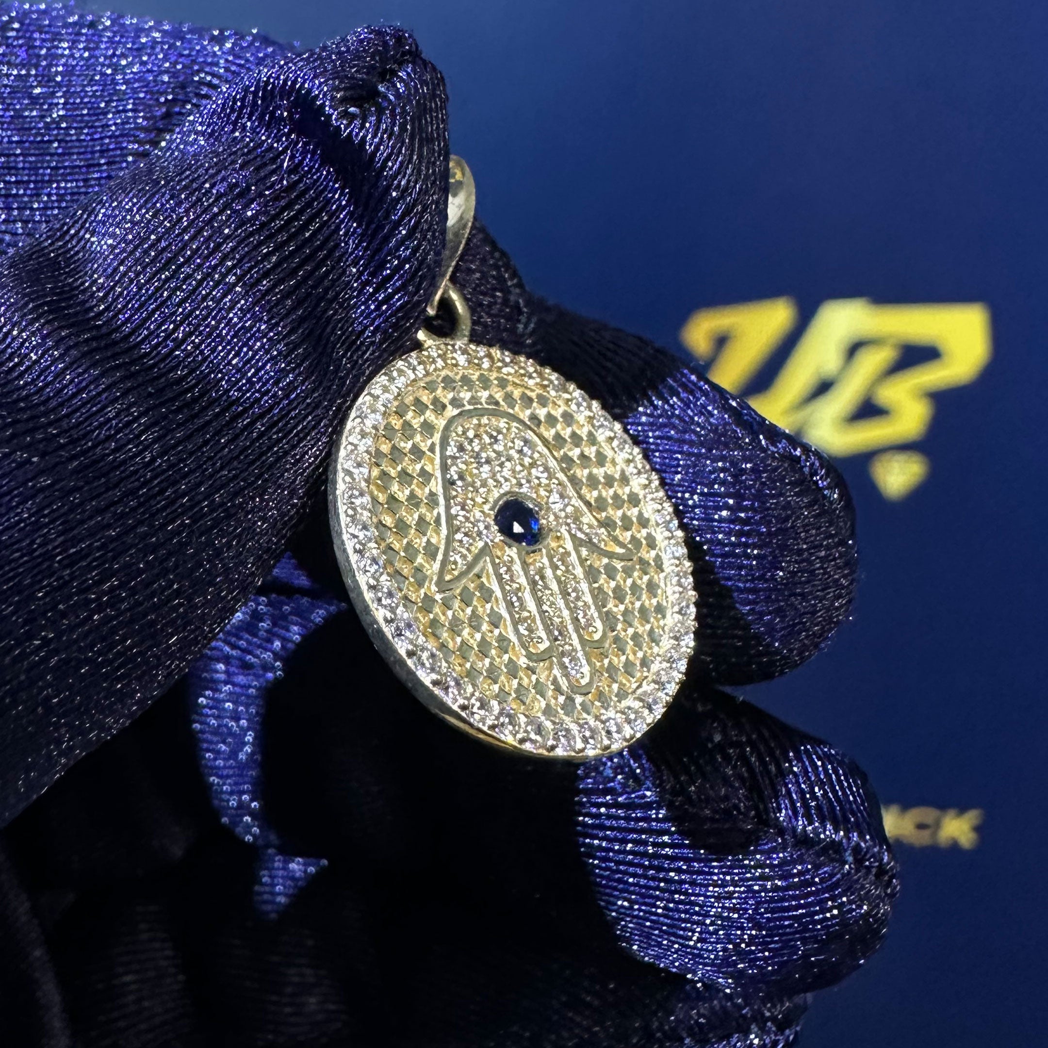 14k CZ Hamsa Hand Round Pendant in hand at angle