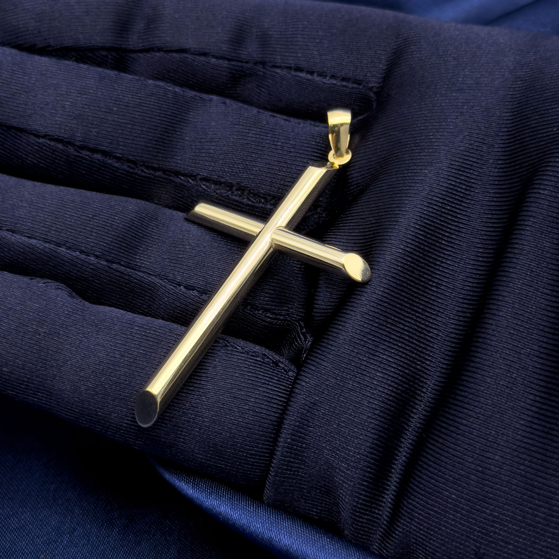 10k yellow gold polished cross pendant on blue background