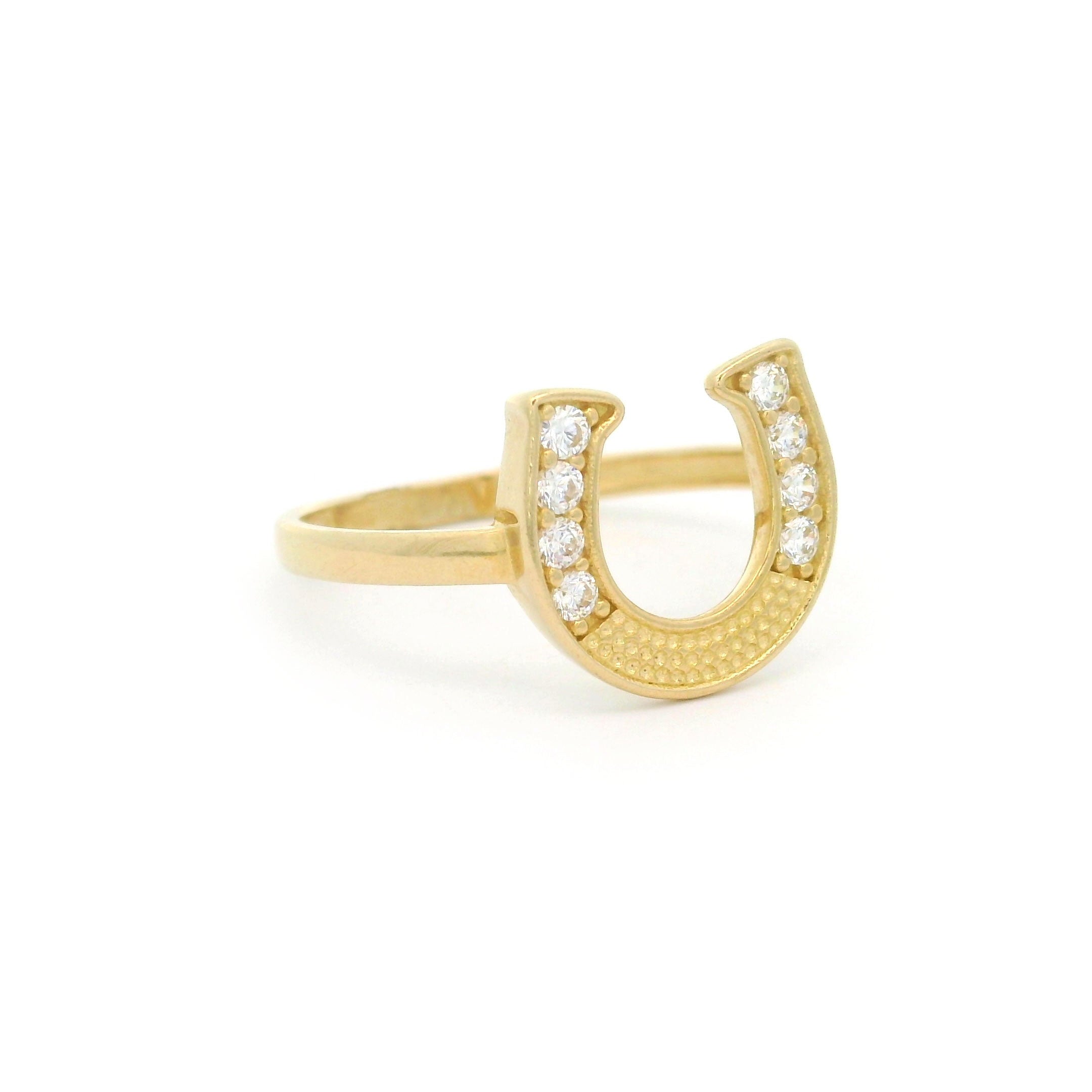 10k yellow gold horseshoe ring with stones on white background left side