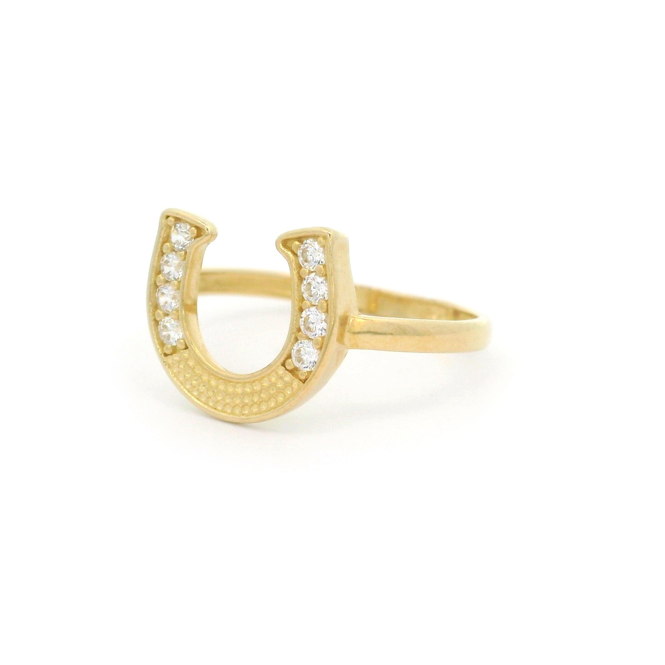 10k yellow gold horseshoe ring with stones on white background right side