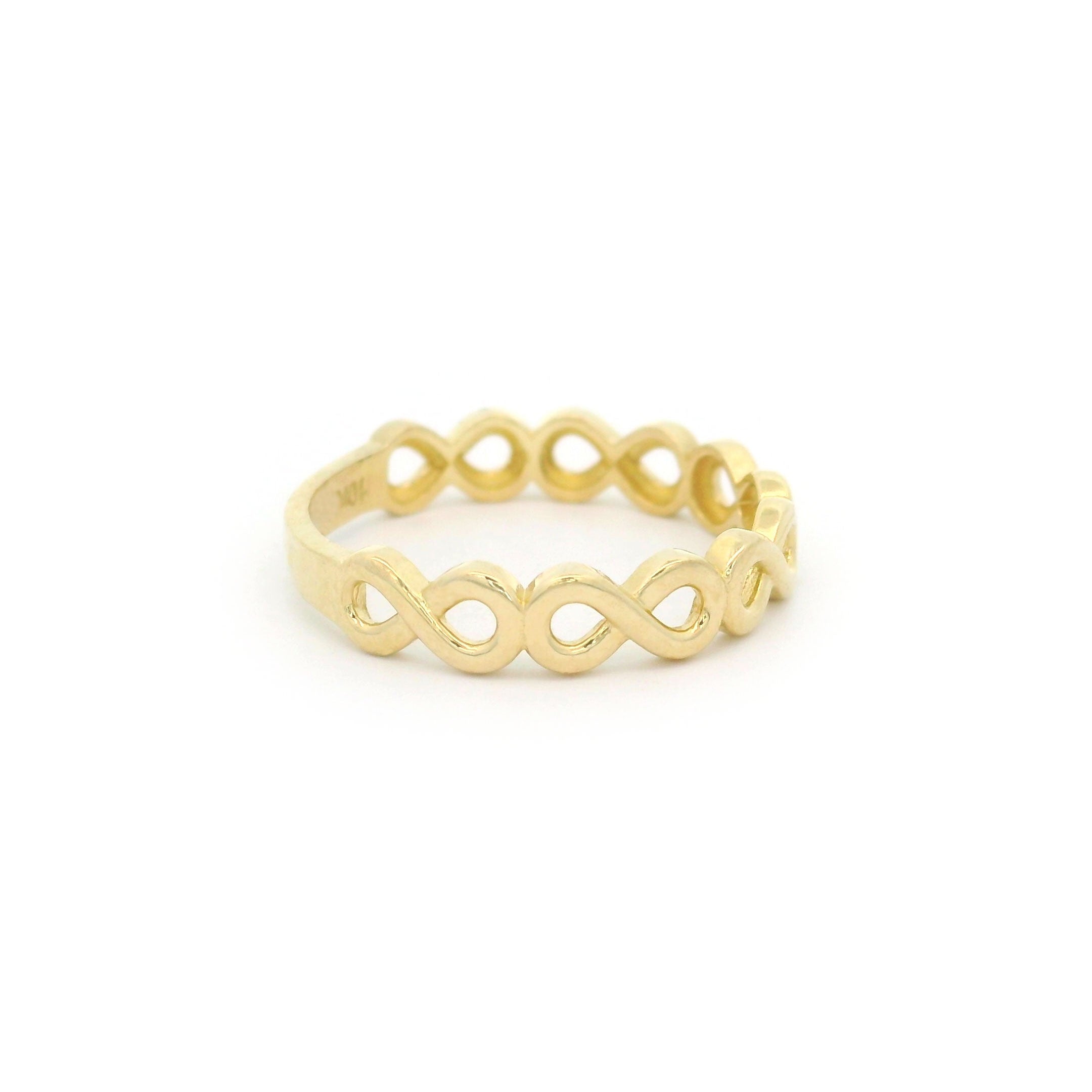 10k yellow gold ring with a infinity design on a white background side view