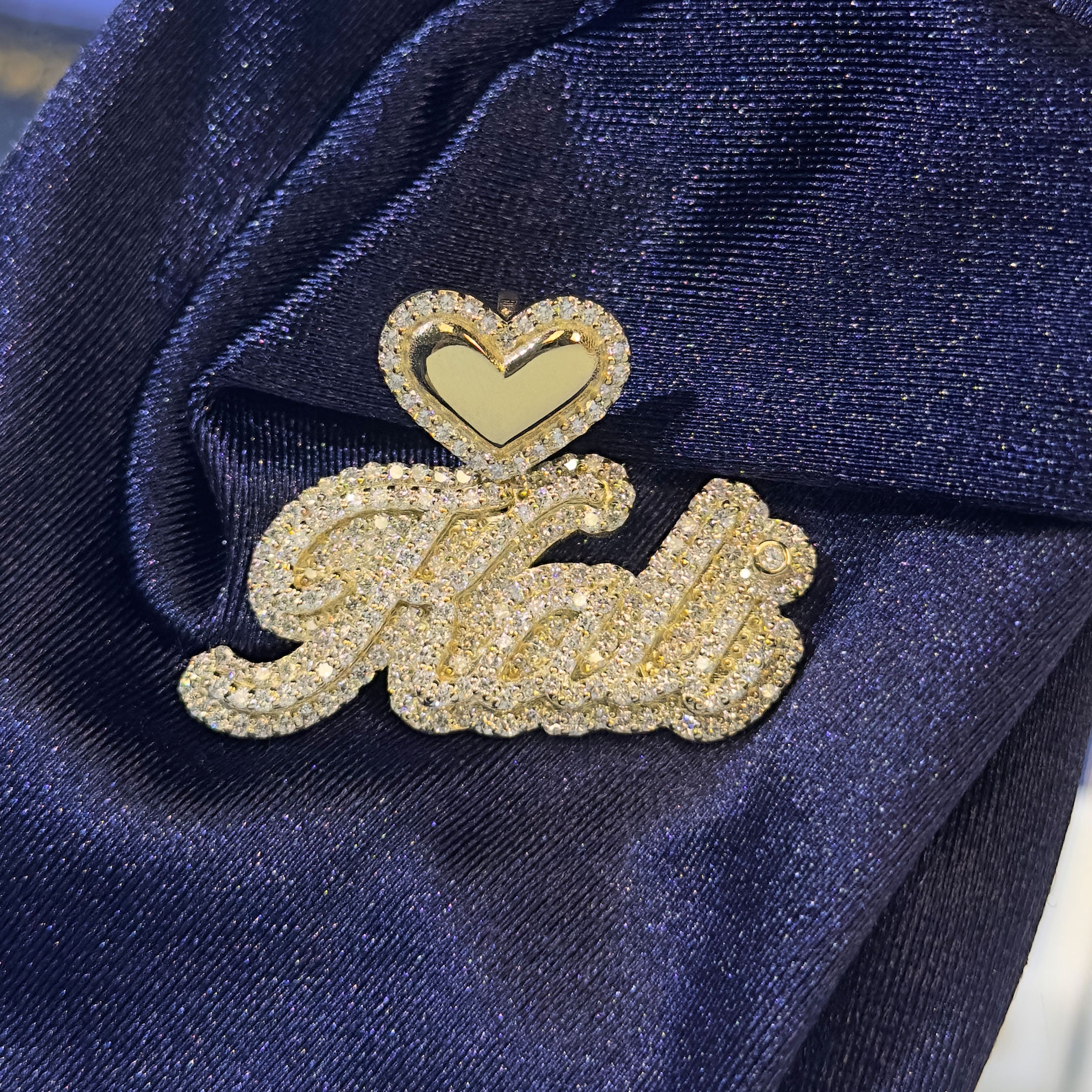 Gold and Diamond Kali Name Pendant with Heart Bale with blue background