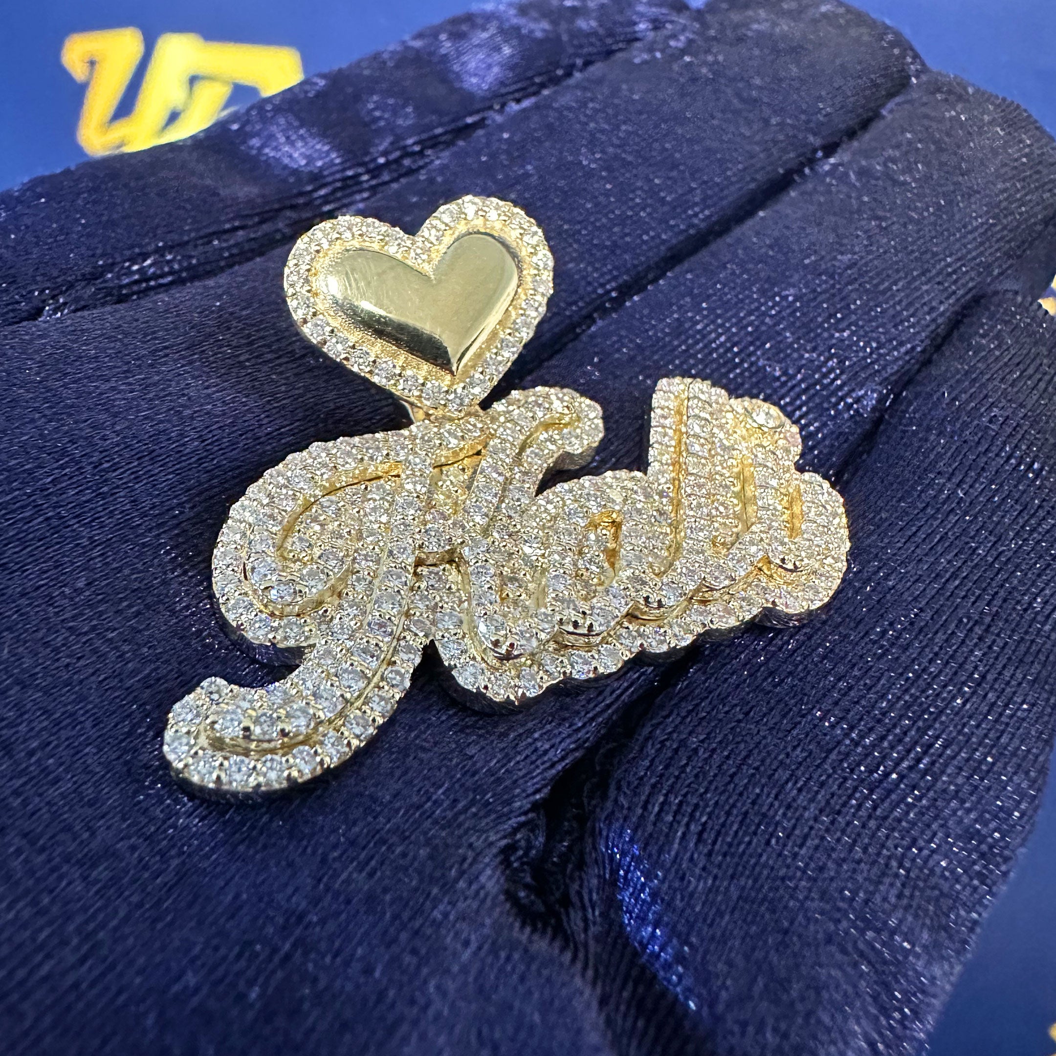 Gold and Diamond Kali Name Pendant with Heart Bale with blue background