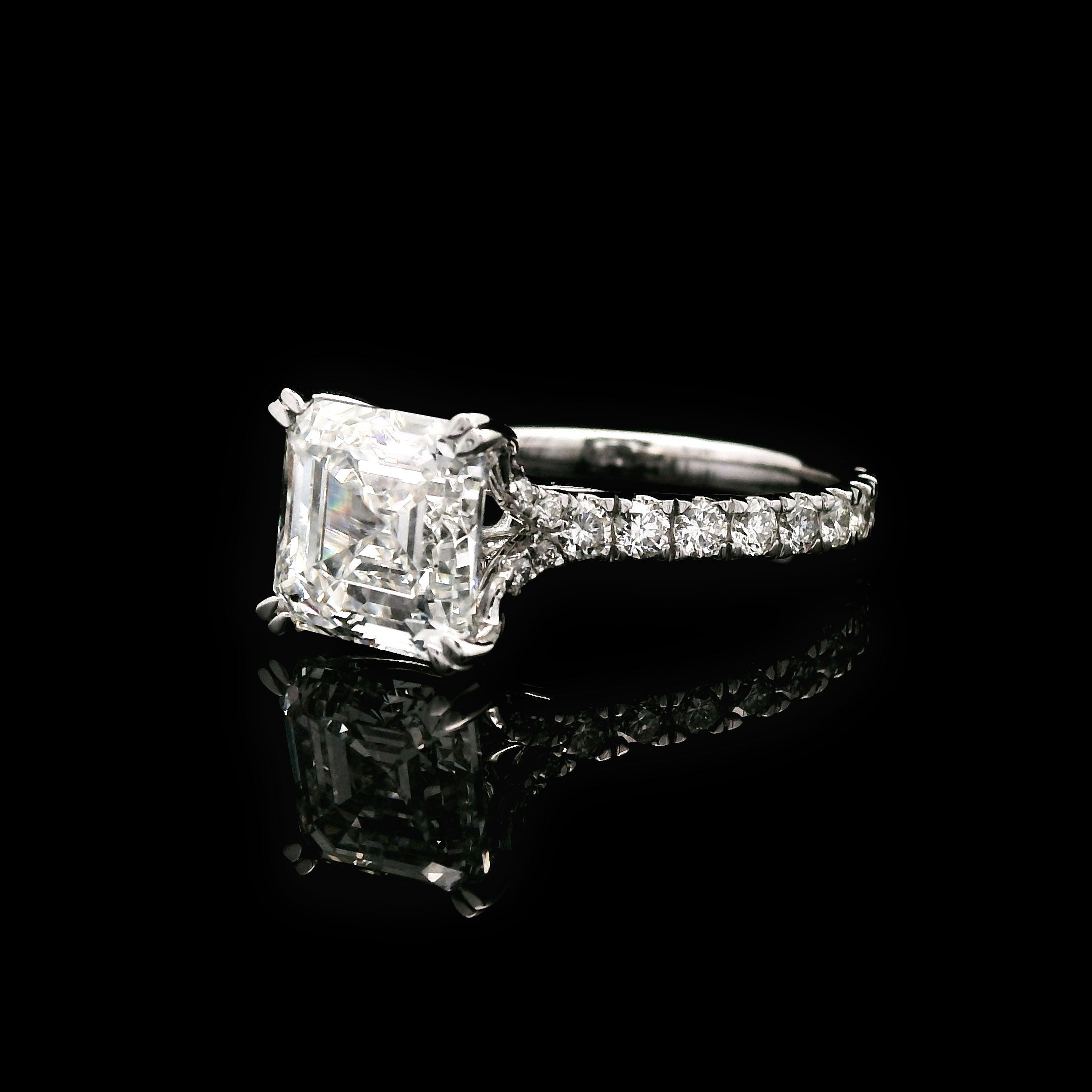 Diamond engagement ring with 3 carat Asscher cut center stone on a black background right side