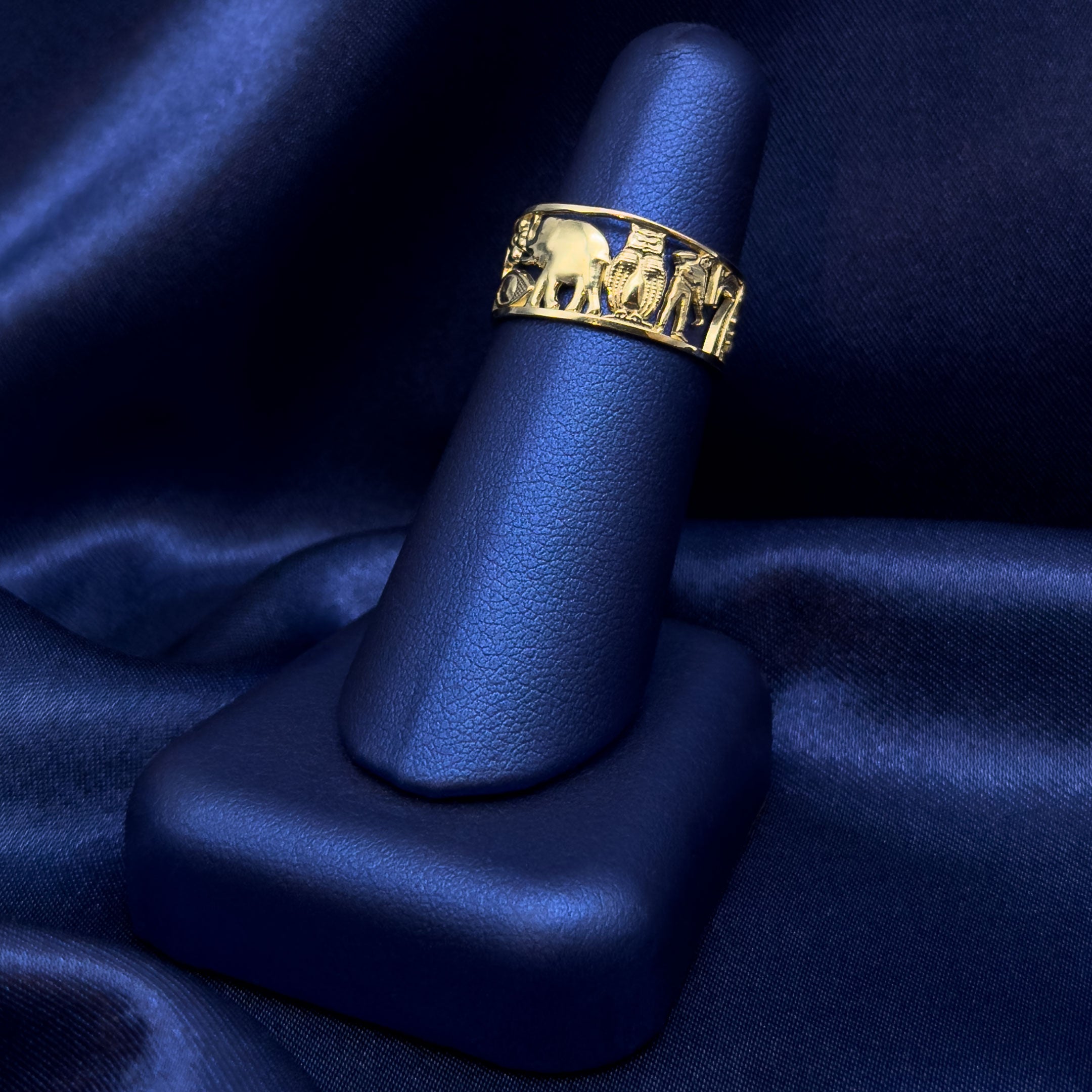 10k Gold Lucky Symbols Ring on a blue satin background