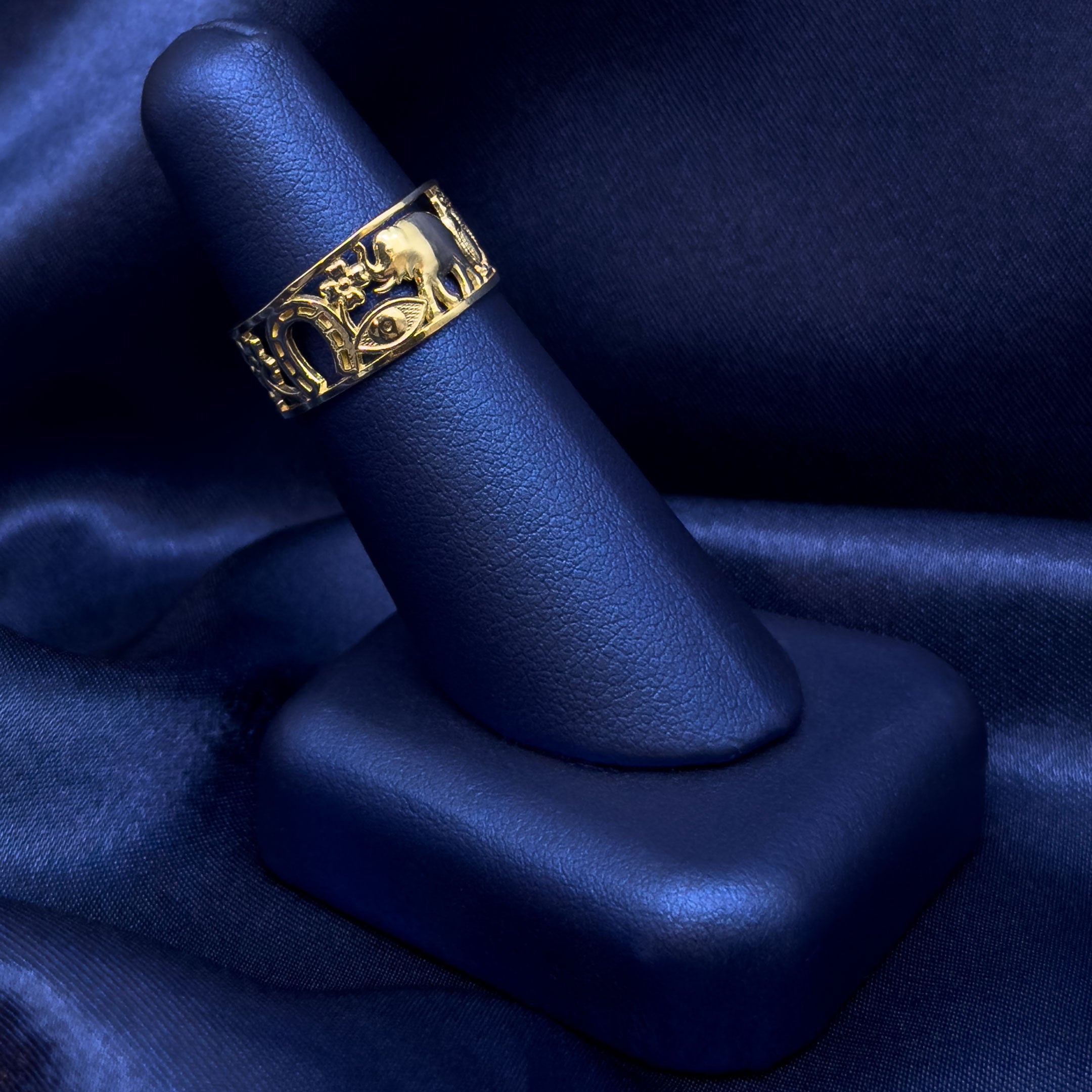 10k Gold Lucky Symbols Ring on a blue satin background side