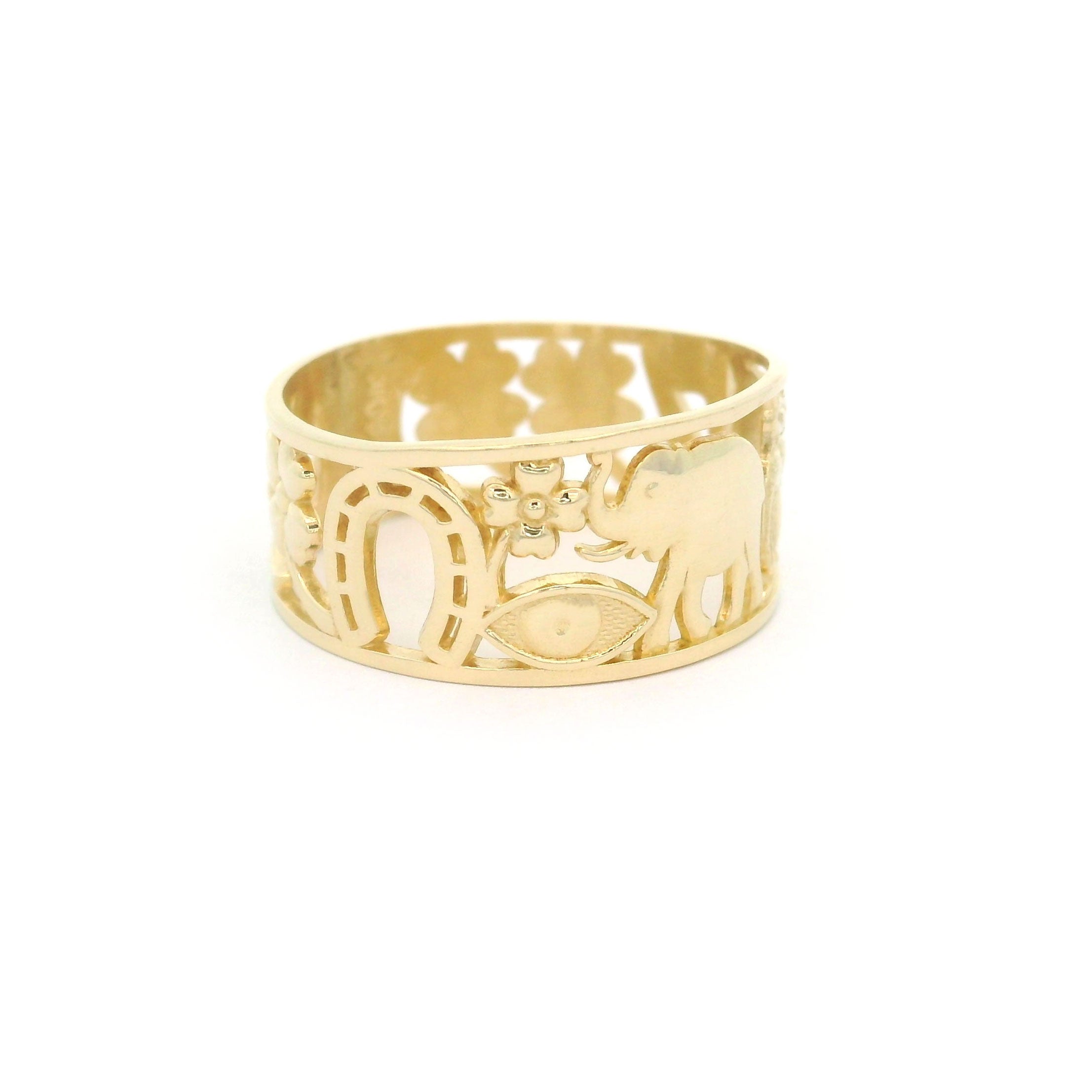 10k yellow gold ring with lucky horseshoe, clover, evil eye and elephant design on a white background