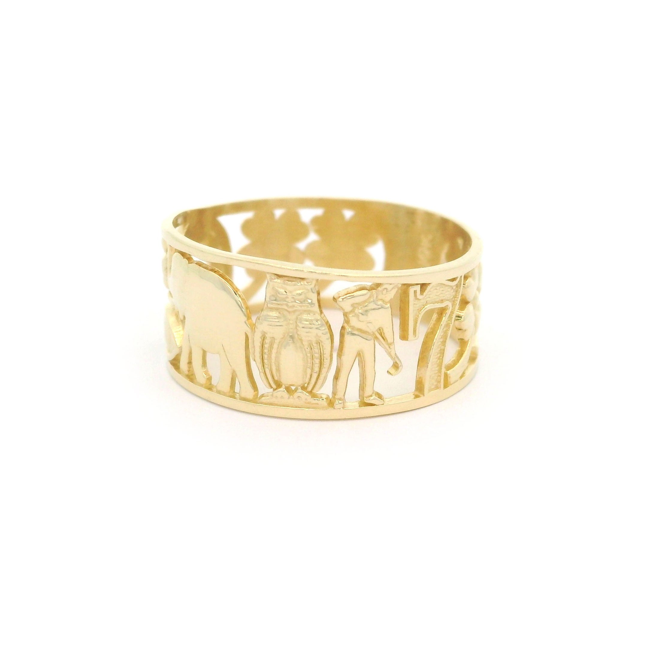 10k yellow gold ring with lucky elephant, owl, farmer and number 7 design on a white background