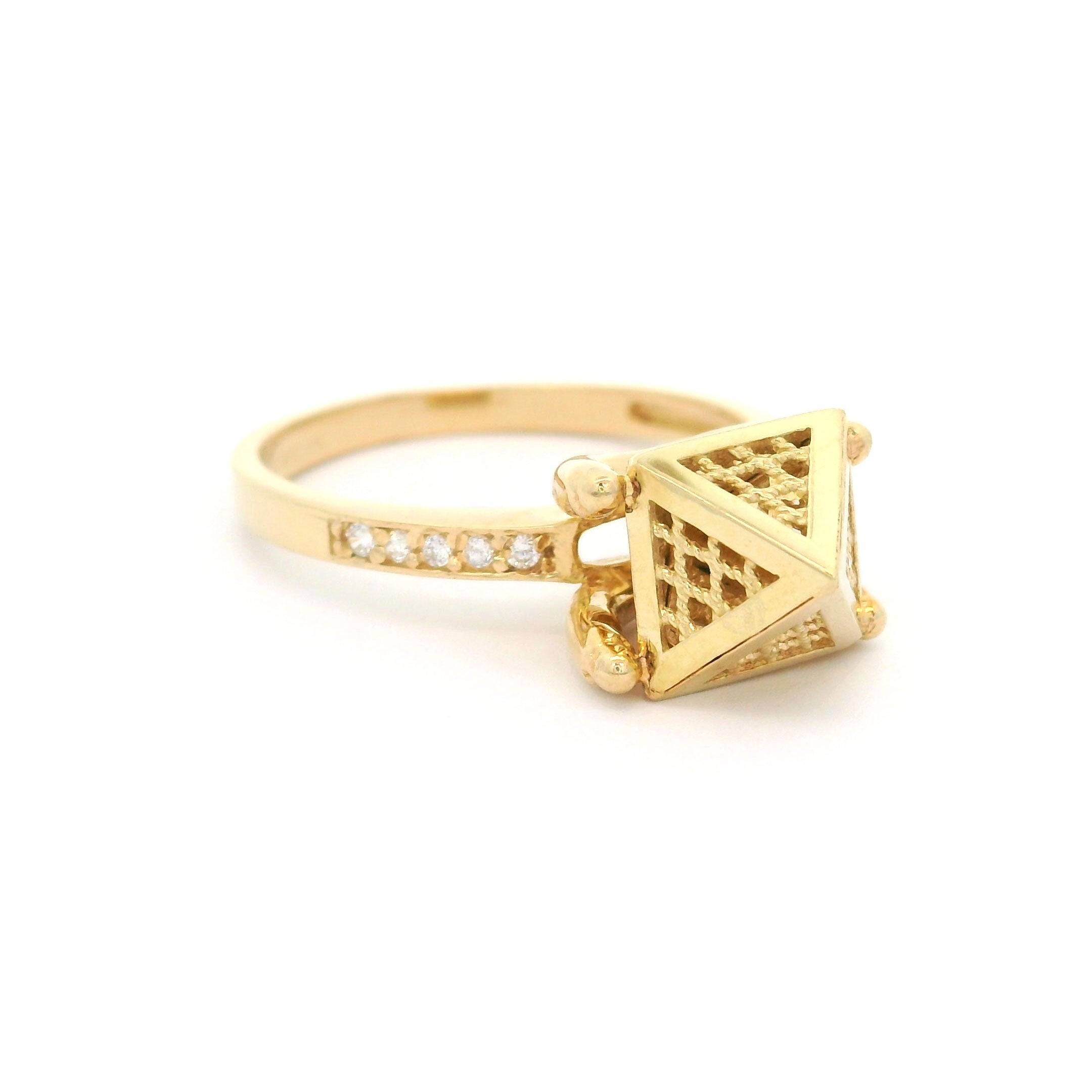 Gold ring with pyramid design on a white background left side