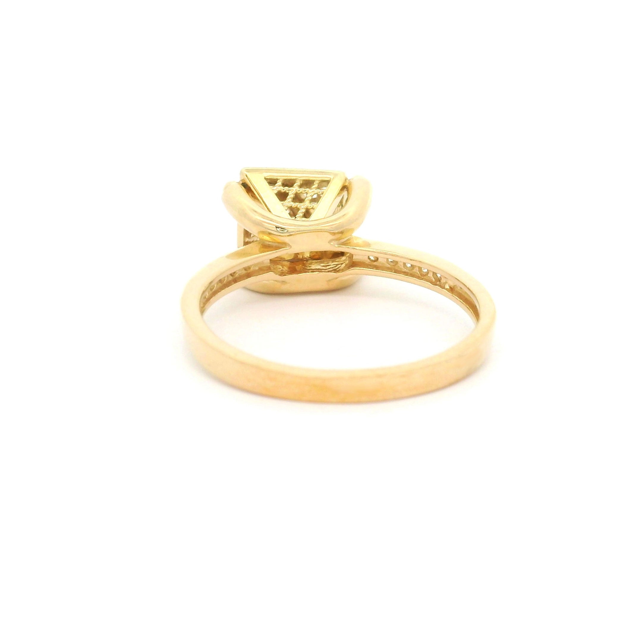 Gold ring with pyramid design on a white background back view