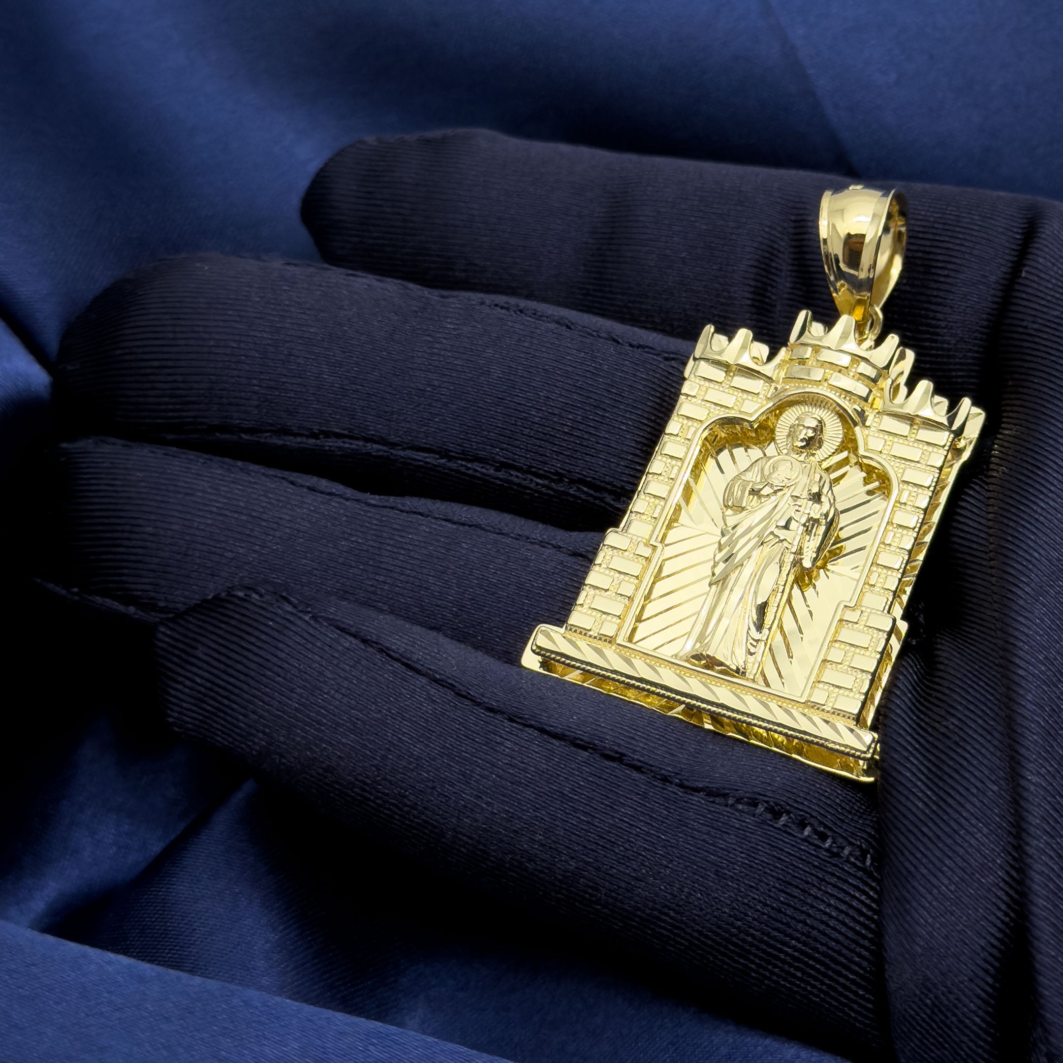 10k Yellow Gold Saint Jude Thaddeus in Castle Frame Pendant on blue background in hand
