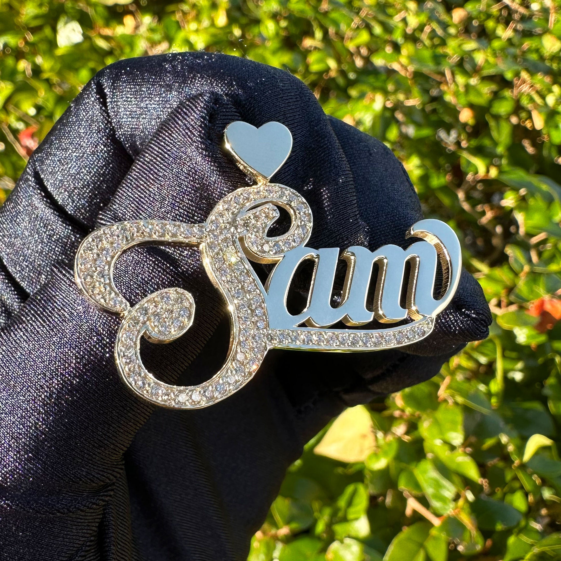 Custom Sam name with Diamond Capitol Letter and Underline in a Hand with Blue Glove with a Greenery Background