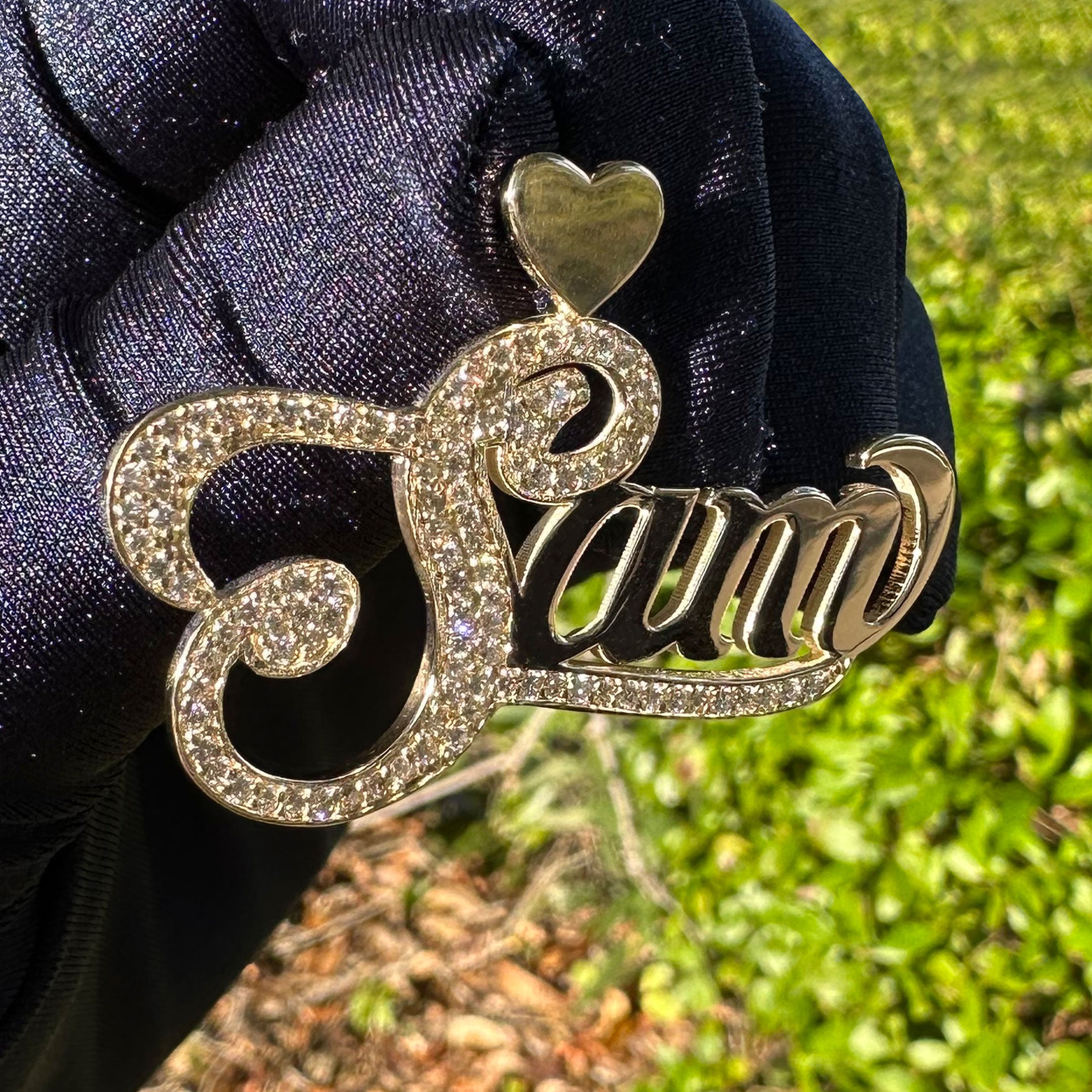 Custom Sam name with Diamond Capitol Letter and Underline in a Hand with Blue Glove with a Greenery Background Close