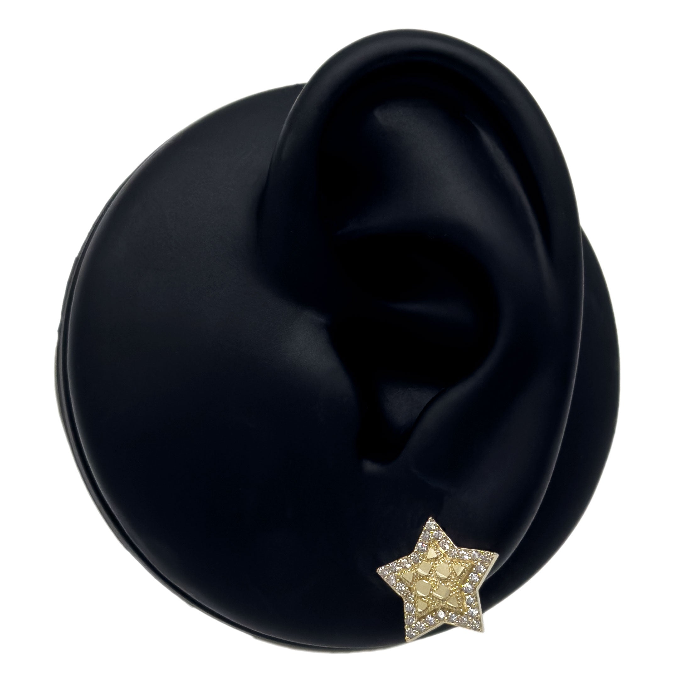 10k gold old star shaped earrings with cz stone border on a black silicone ear display