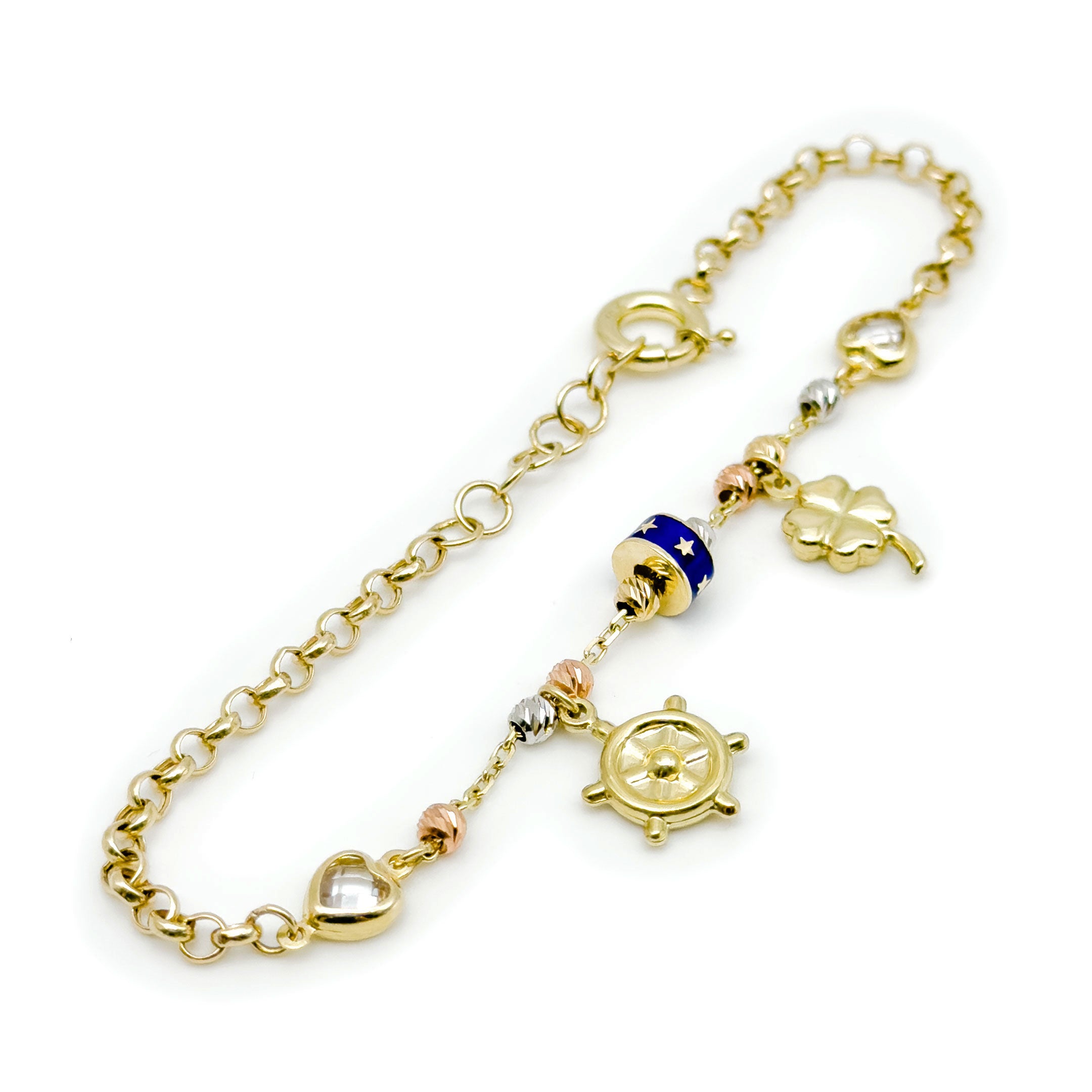 A gold charm bracelet with charms, including a ship's wheel, a four-leaf clover, a heart, and a blue and gold star-patterned bead, shown on a white background. angled