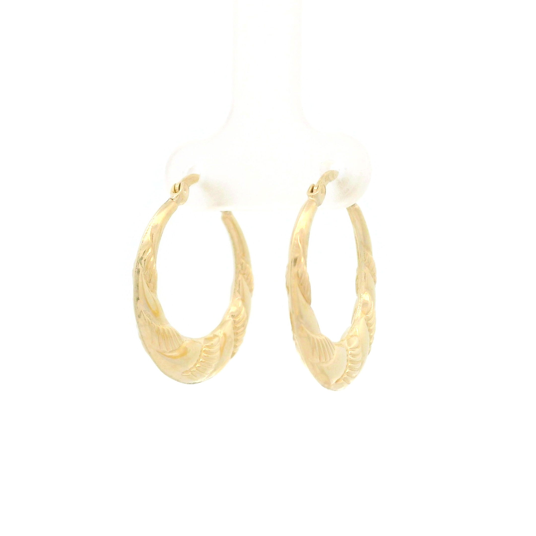 10k gold hoop earrings with swirl design on white background