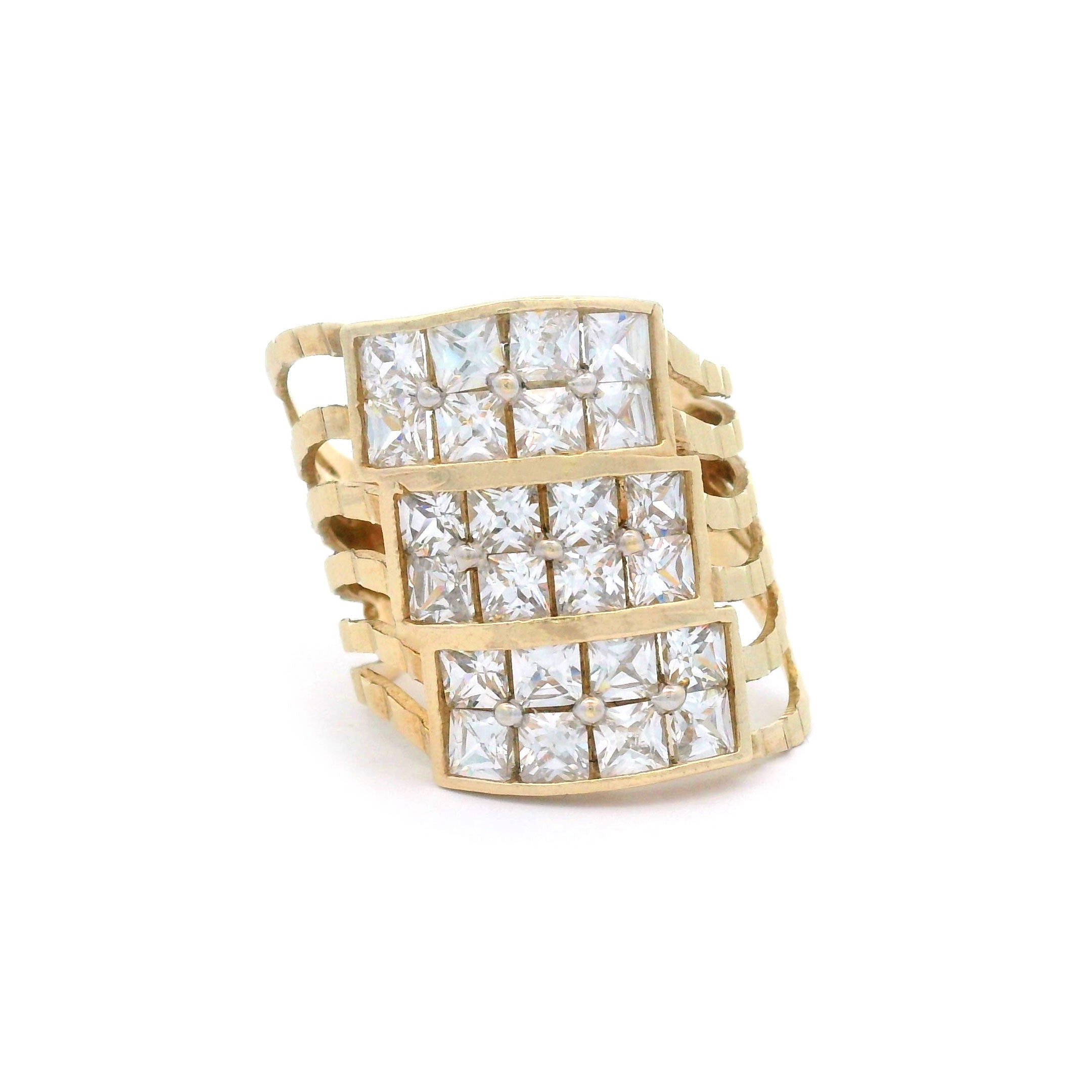 Gold ring with square-cut diamonds on a white background