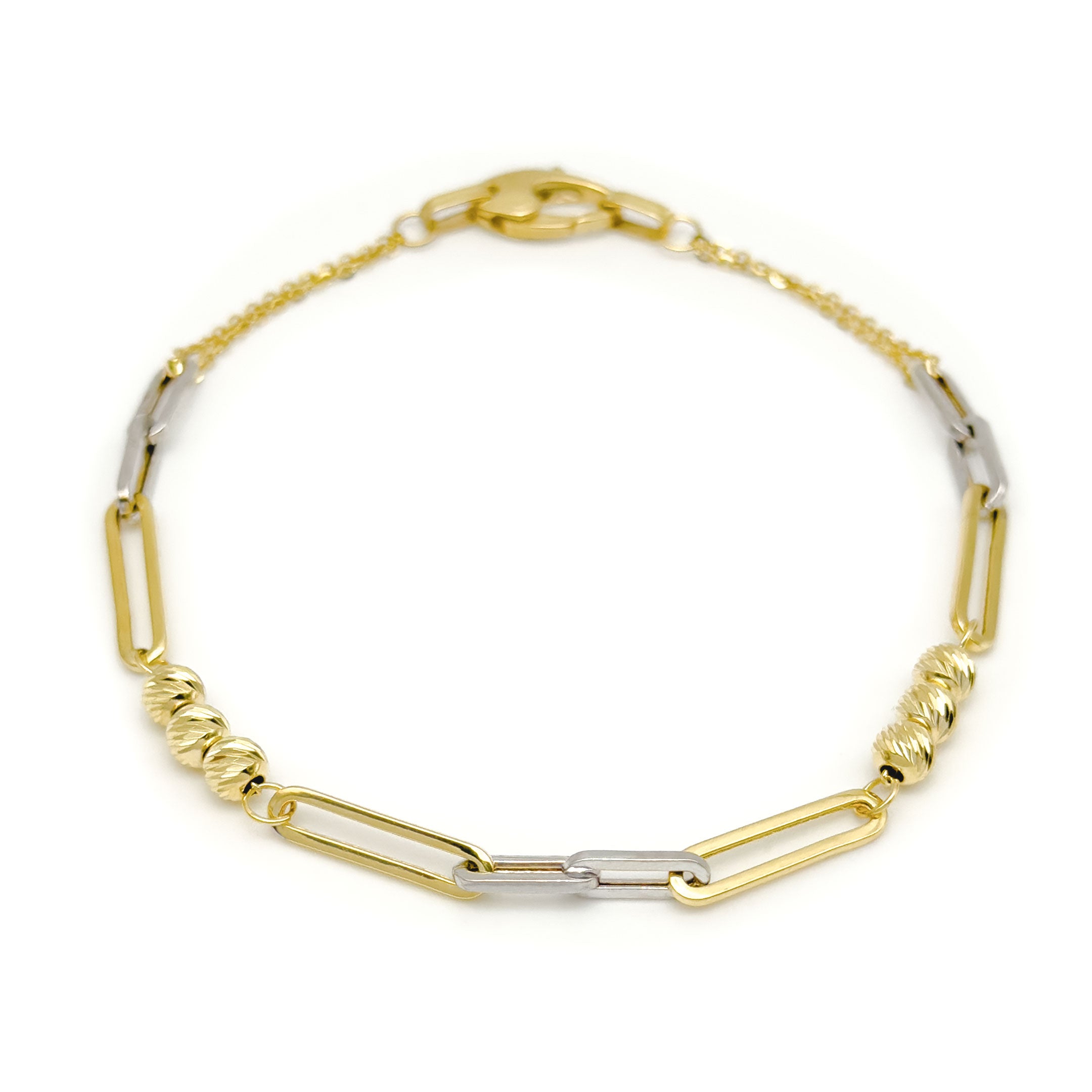 A two-tone yellow gold and white gold paperclip link chain bracelet with triple ball design on a clean white background.