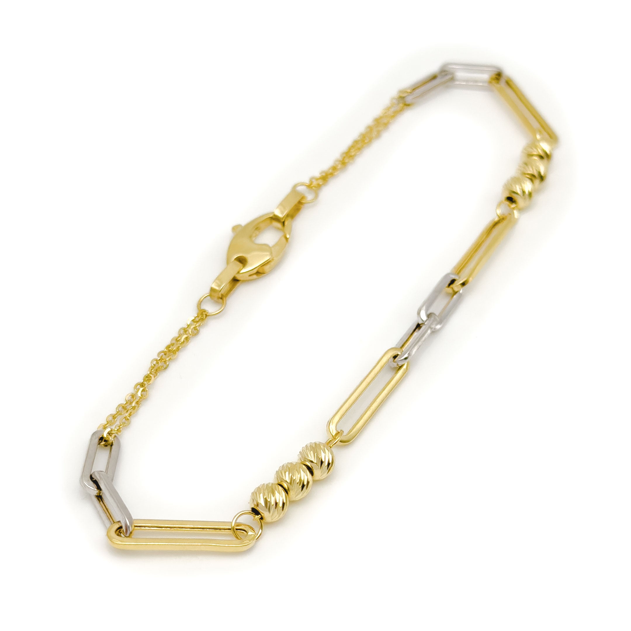 A two-tone yellow gold and white gold paperclip link chain bracelet with triple ball design on a clean white background. close up