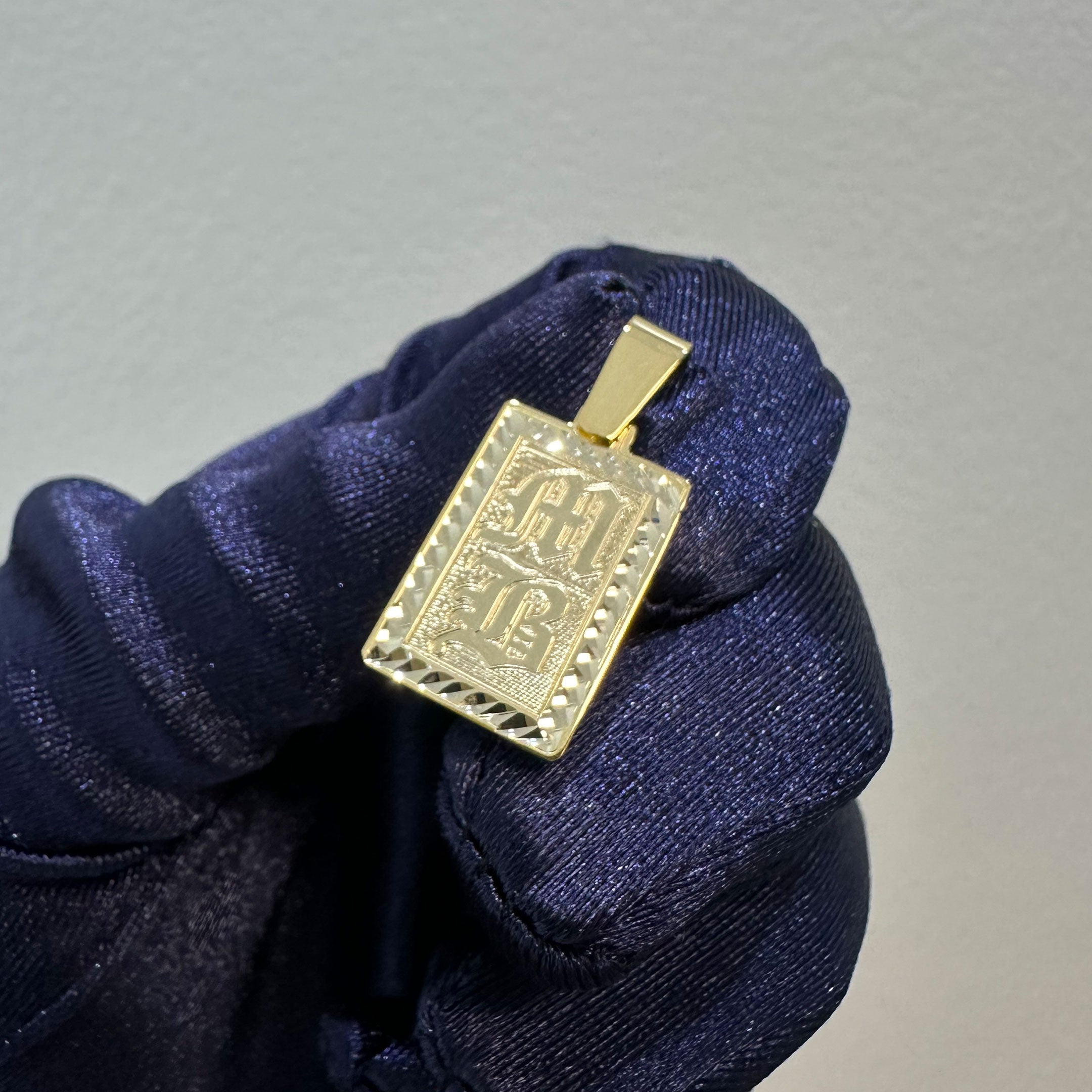 Gold rectangle pendant with diamond cut border and MB engraved in Old English