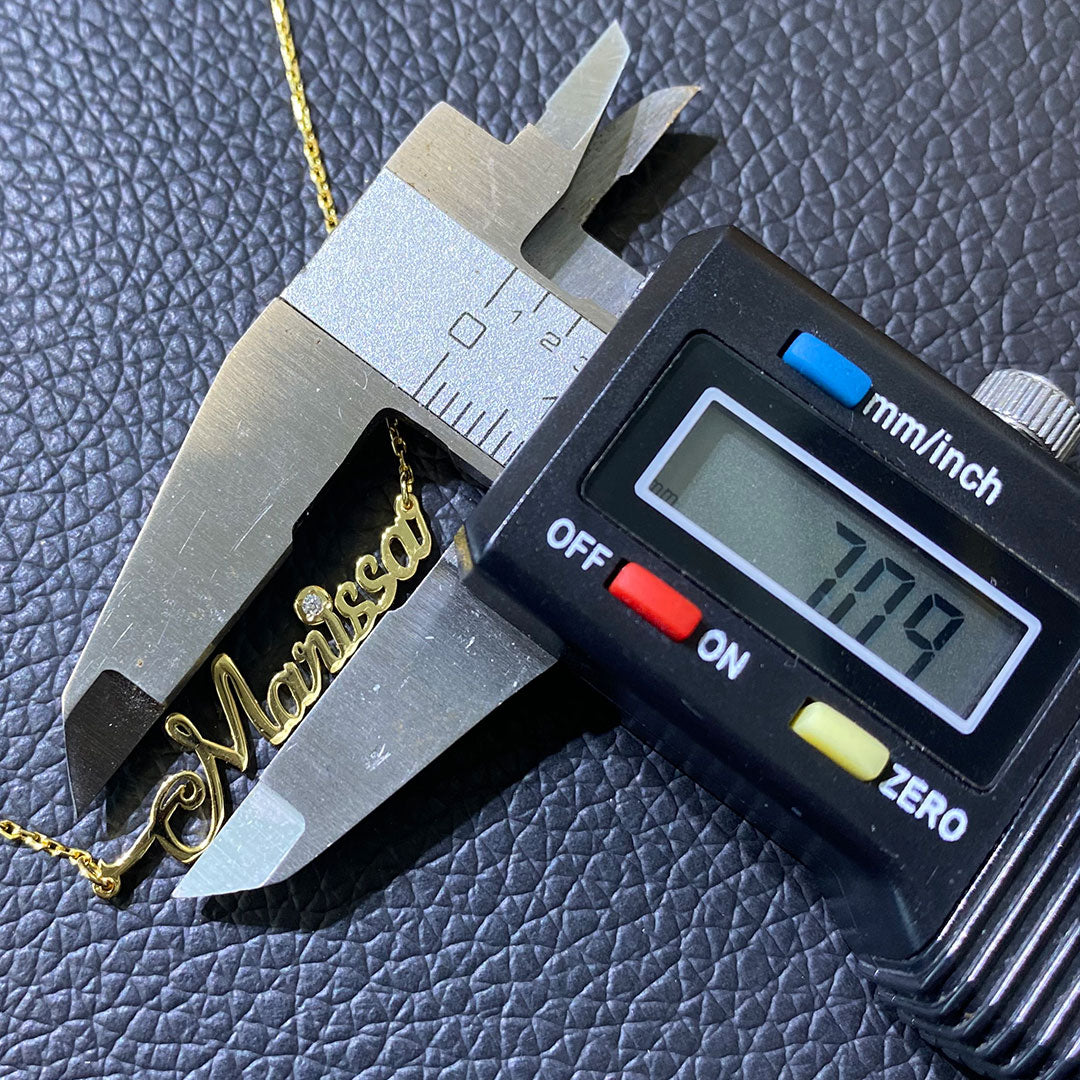 Marissa with gauge to show 7mm letter height for capitol letter.